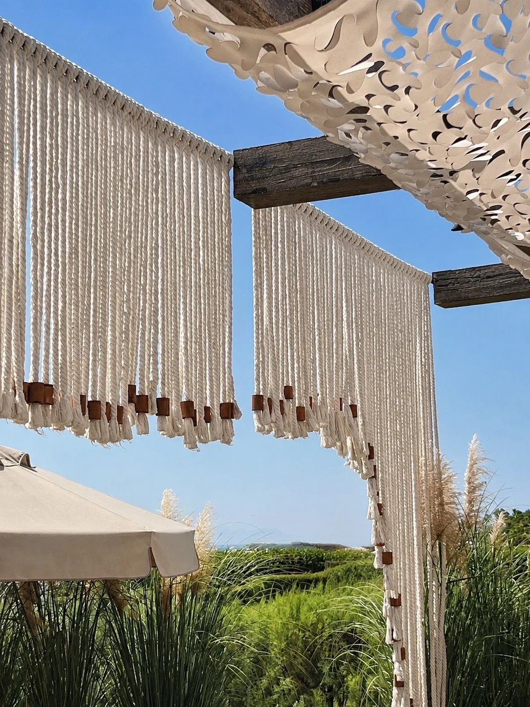 Beaded rope fringe panels hung beneath the cut-pattern shade canopy over the Adalya Bliss terrace