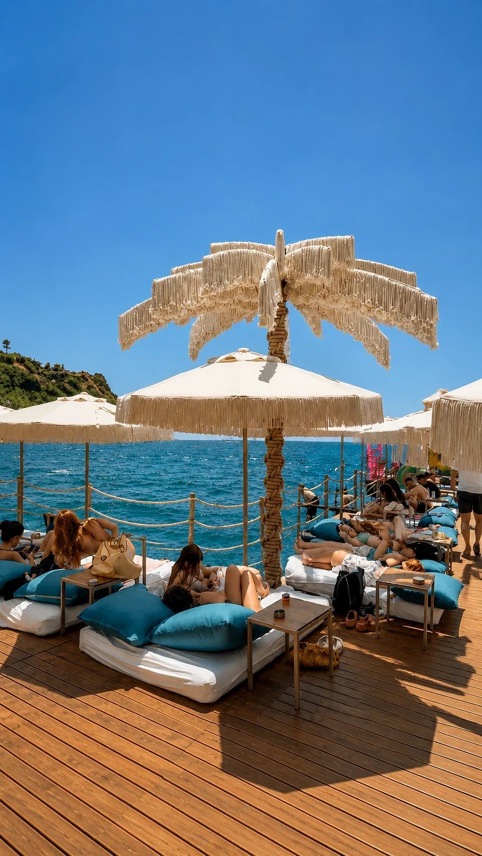 The Dimare Palm Tree rising over the parasols and sunbeds of the Bilem Beach deck