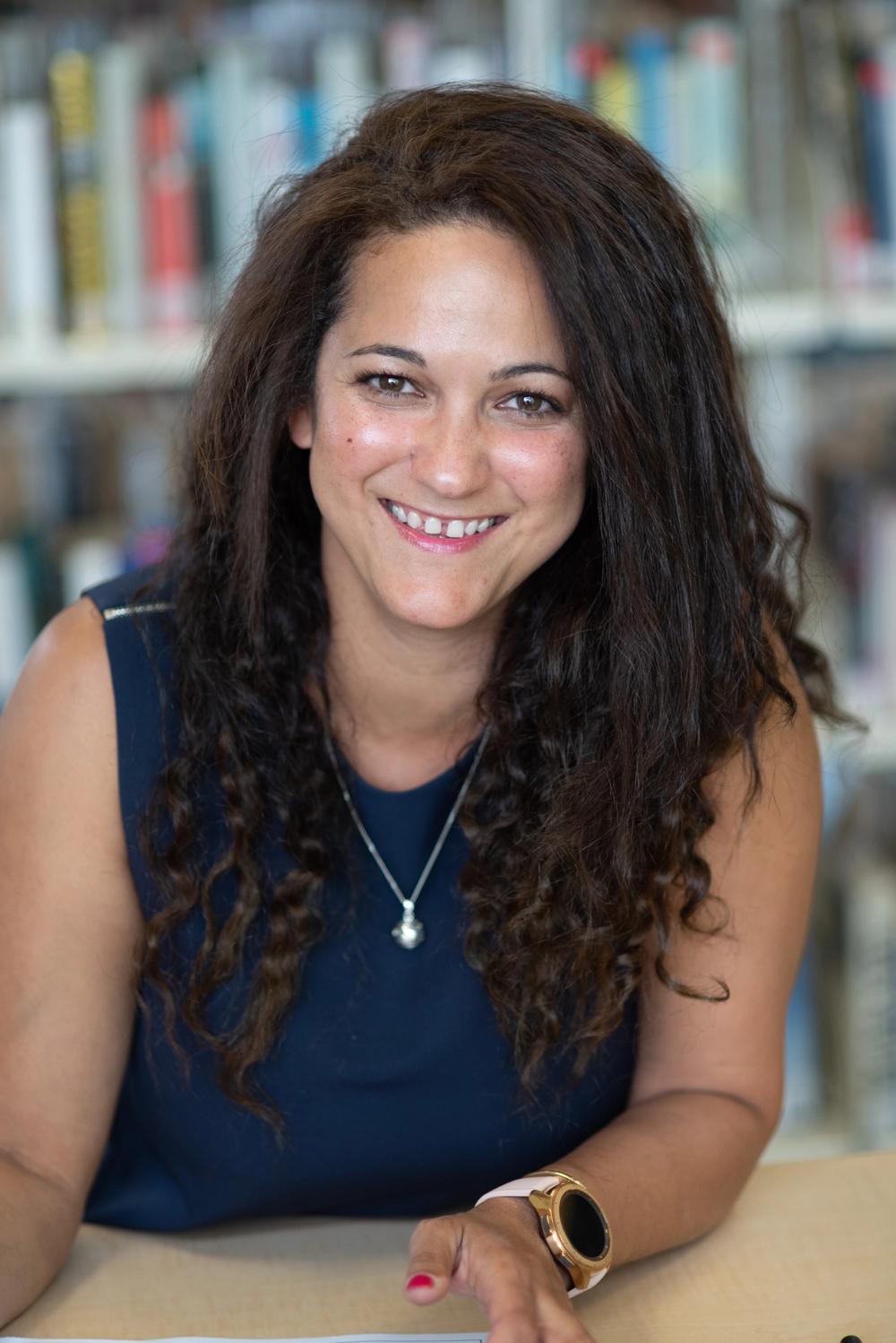 business woman interior designer with books in background