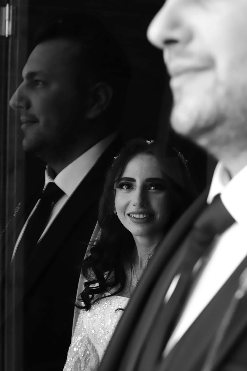A newlywed couple sharing a quiet moment, photographed in classic black and white