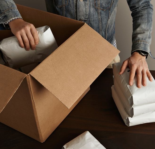 coffee shop box man putting coffee bags in