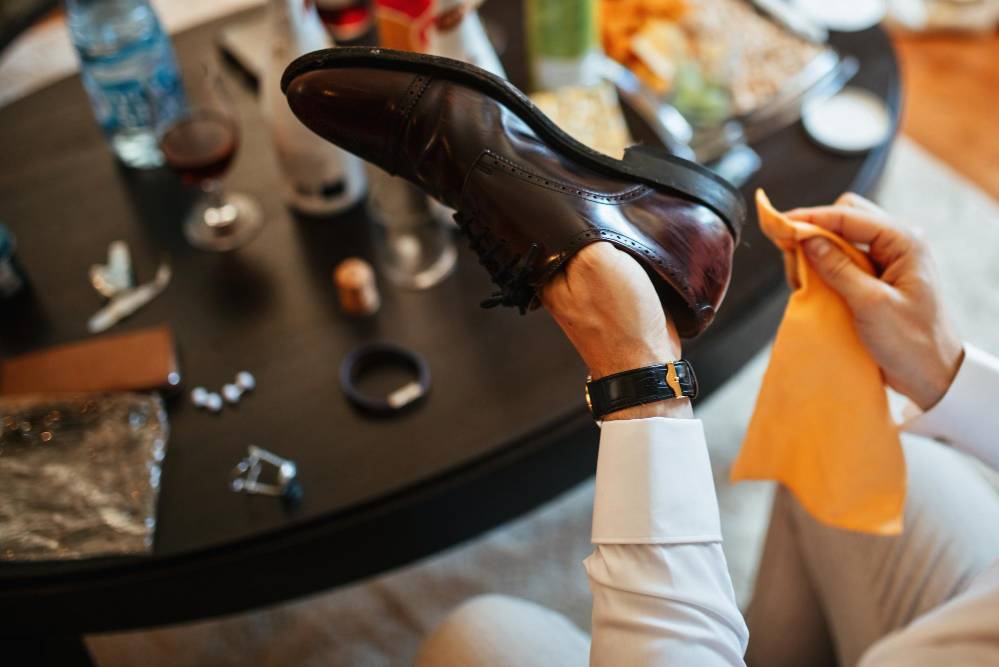 close up of man polishing leather shoe