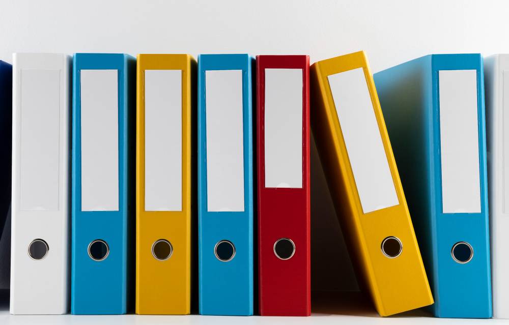 Multi-coloured folders lined up on a wall