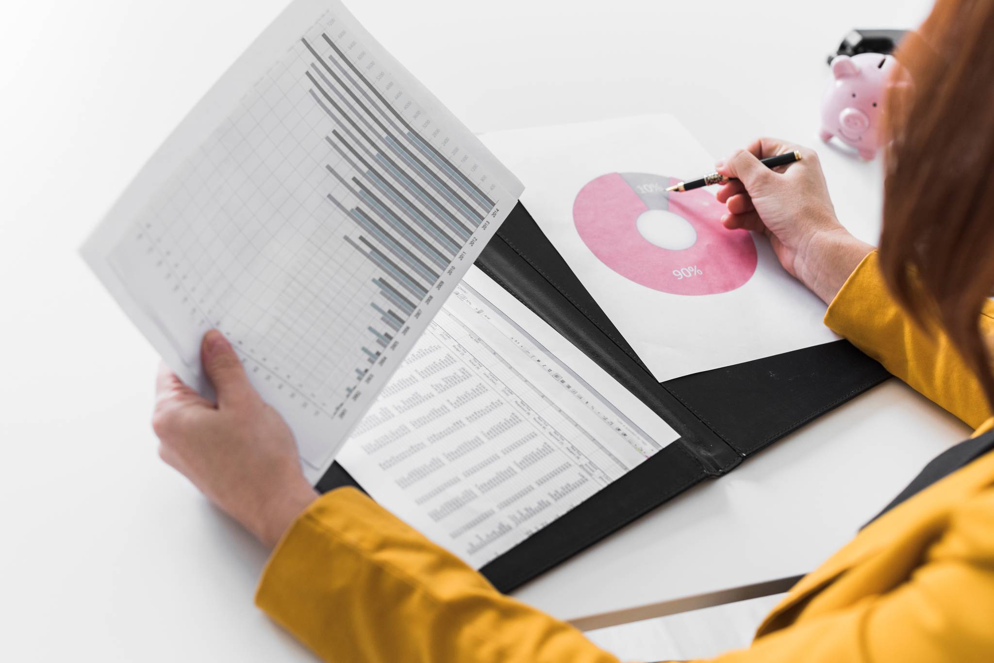 A closeup of a businesswoman analysing graphs.