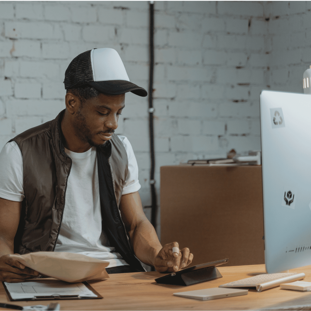 ecommerce worker in storage room on computer