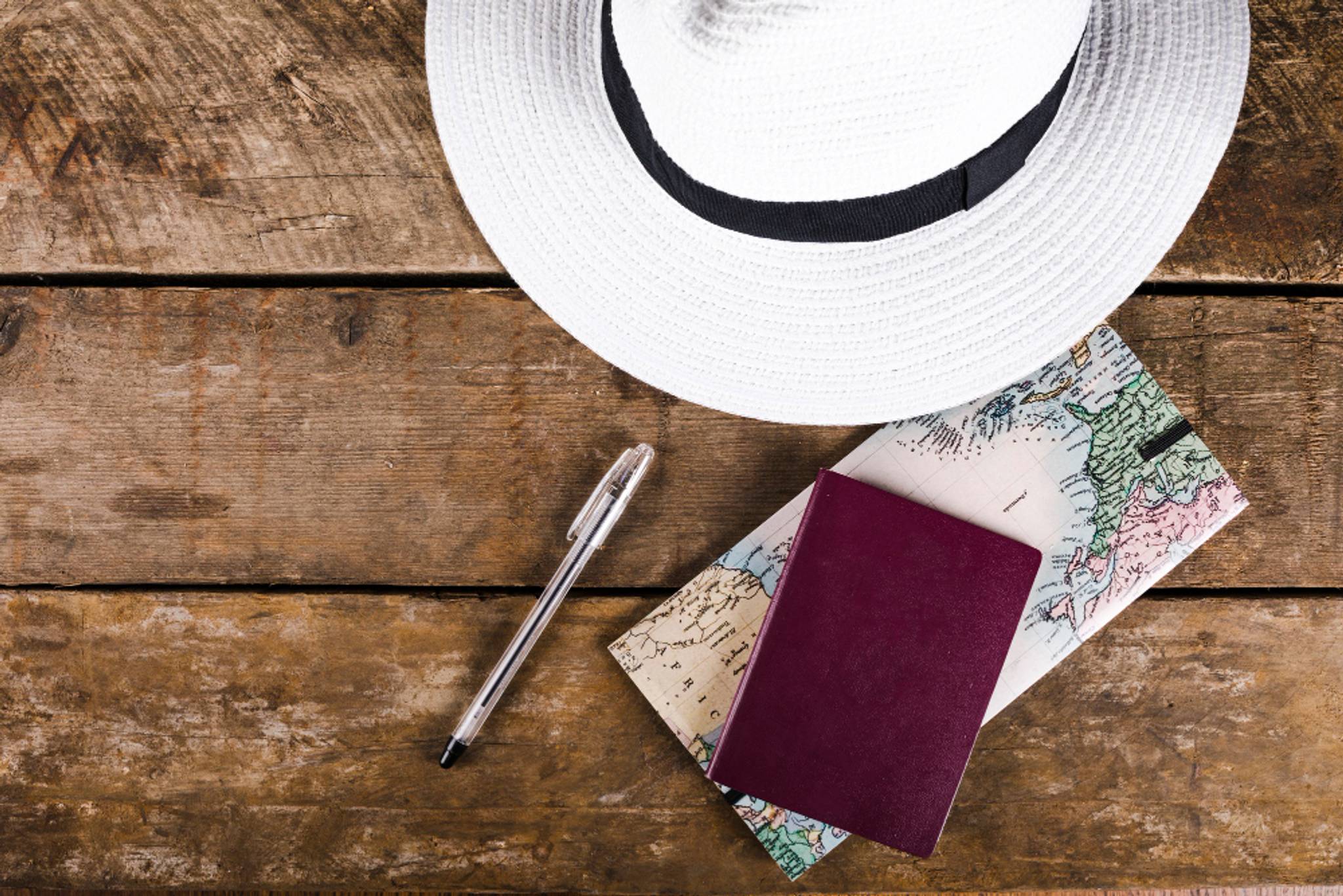 High angle view of traveler's accessories on wooden plank
