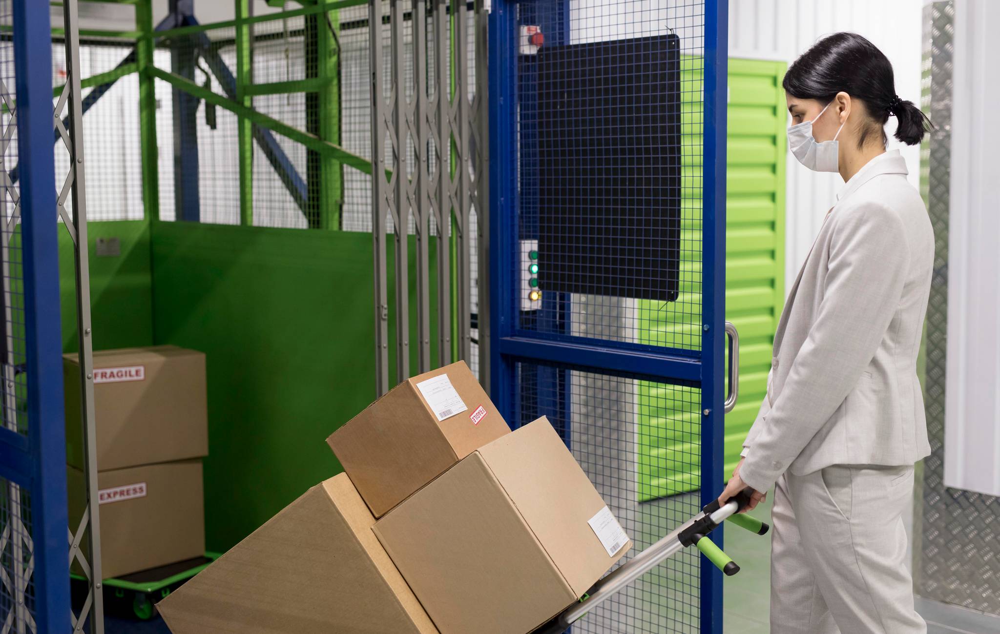 Woman with trolley and boxes storage facility