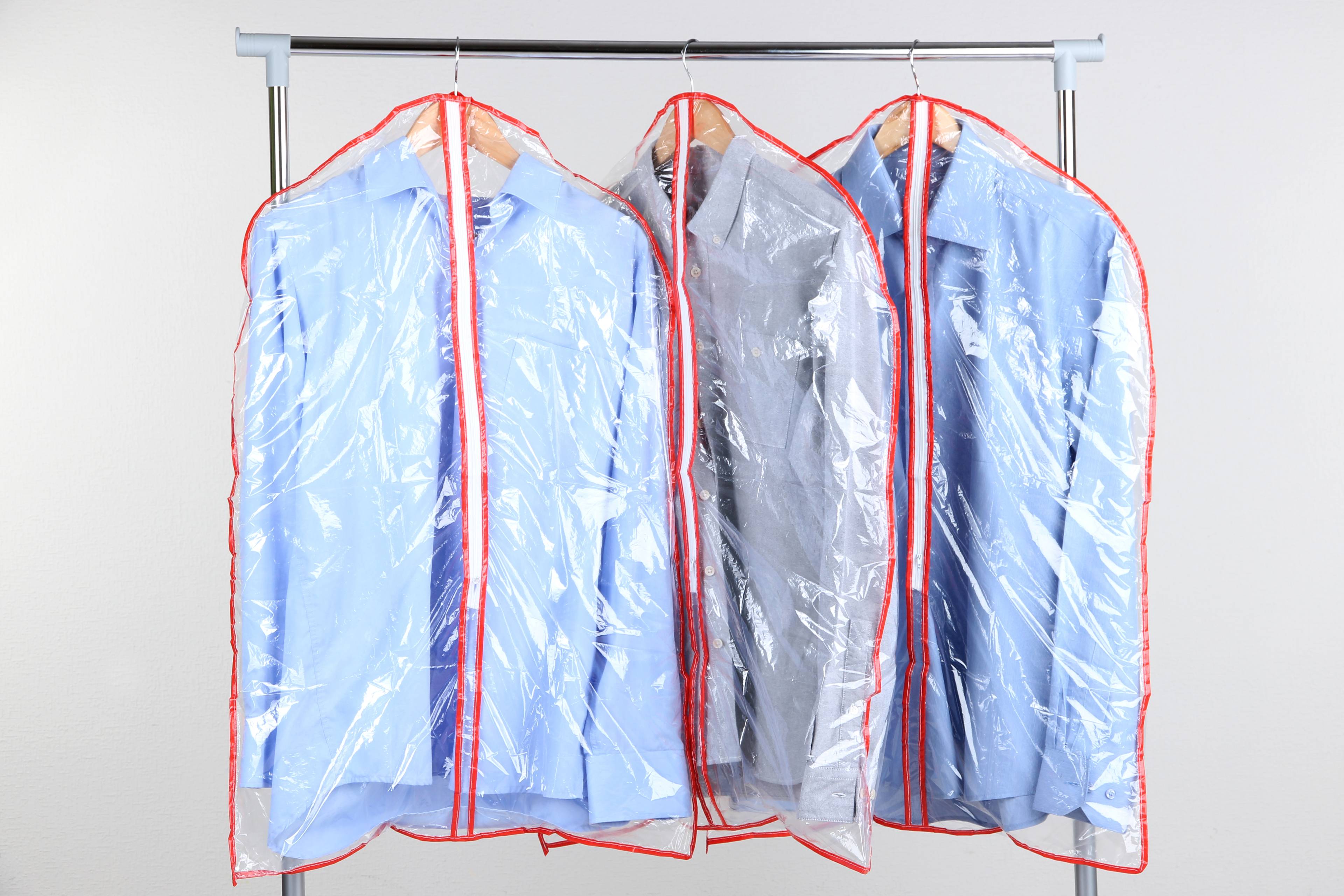 Shirts in plastic bags hanging up