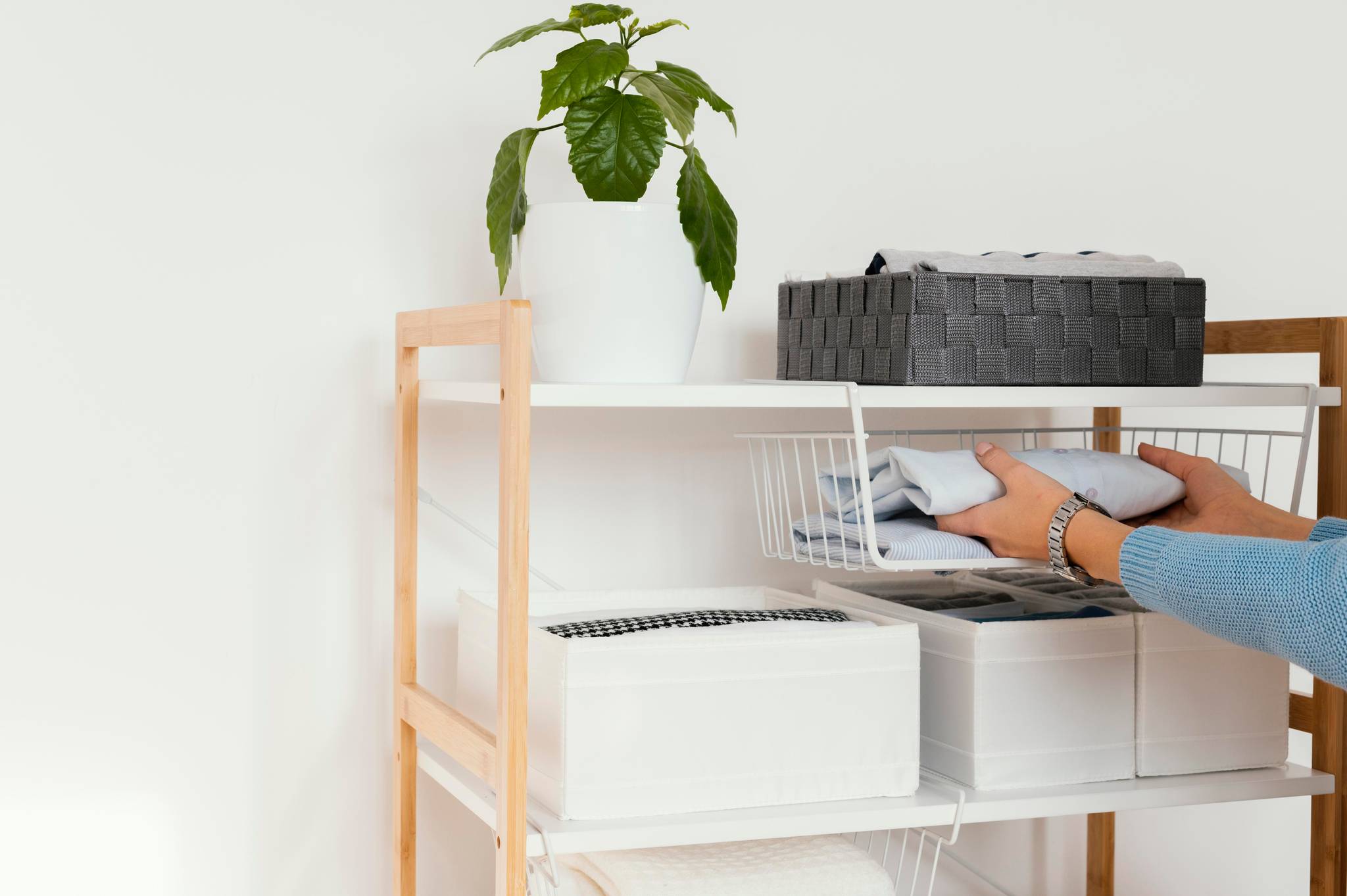 Person packing home storage shelves