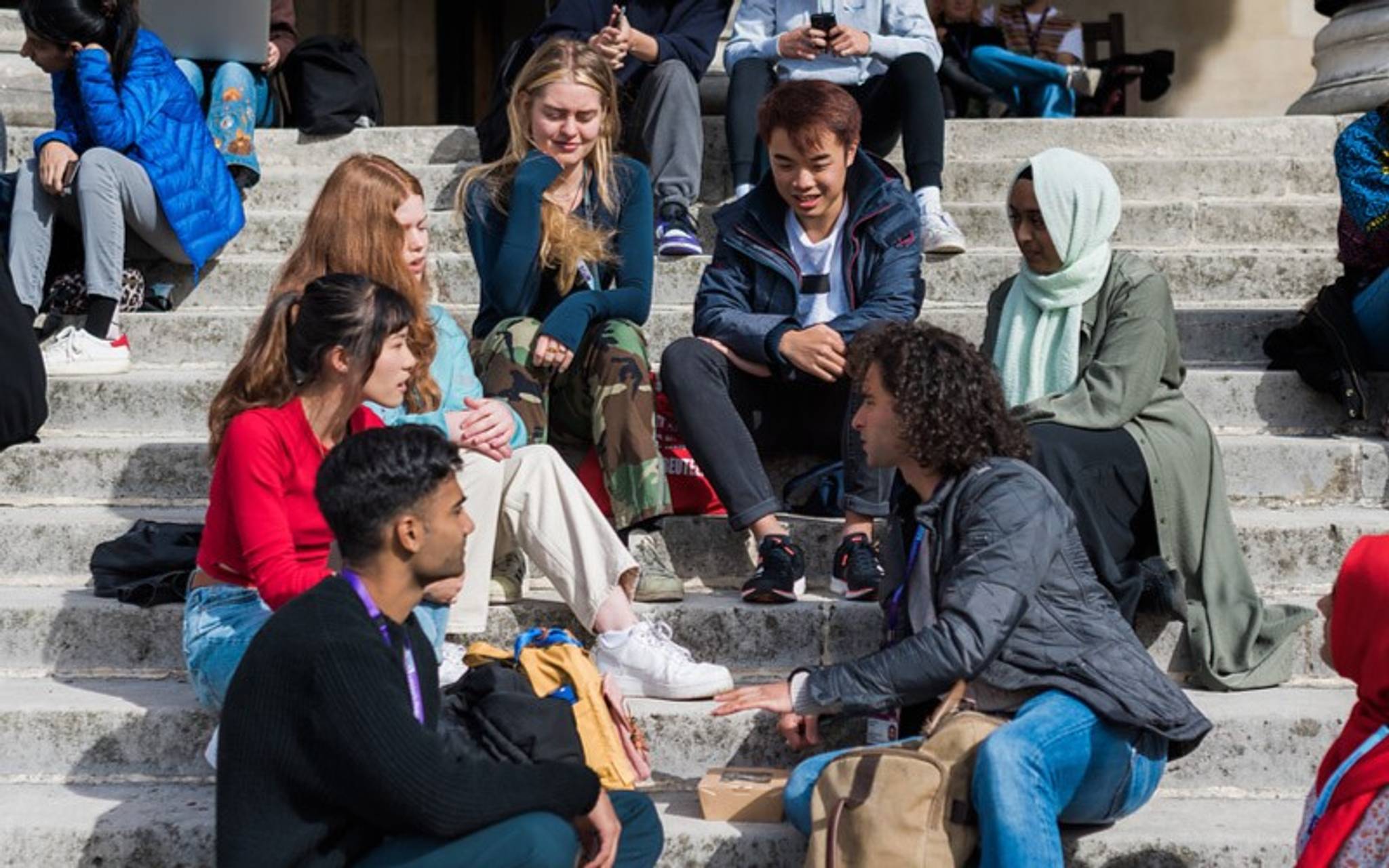 University students sitting on steps