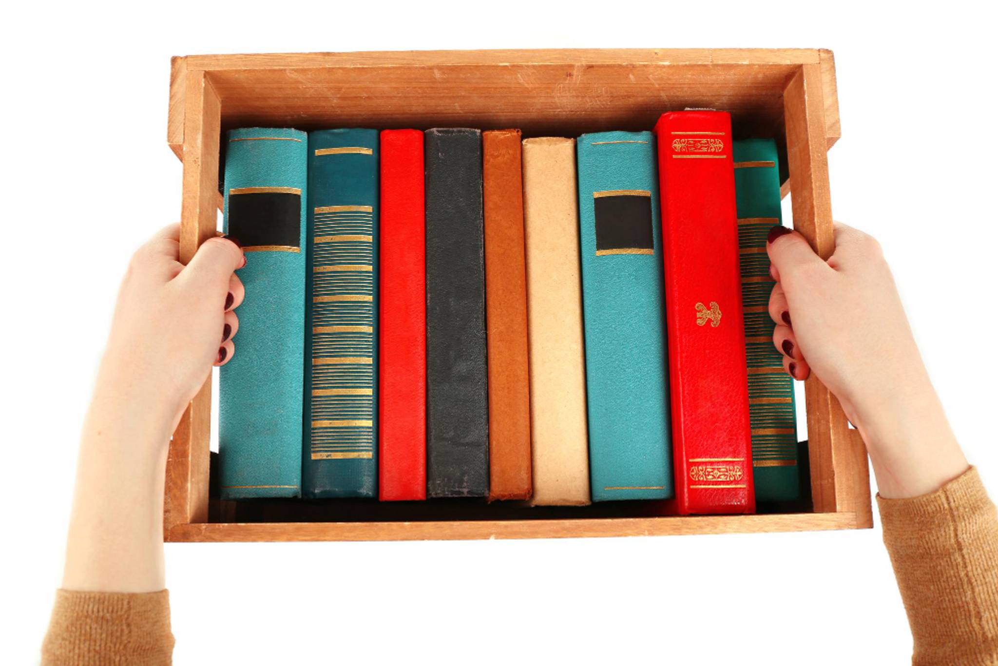 Someone carrying a wooden box filled with books