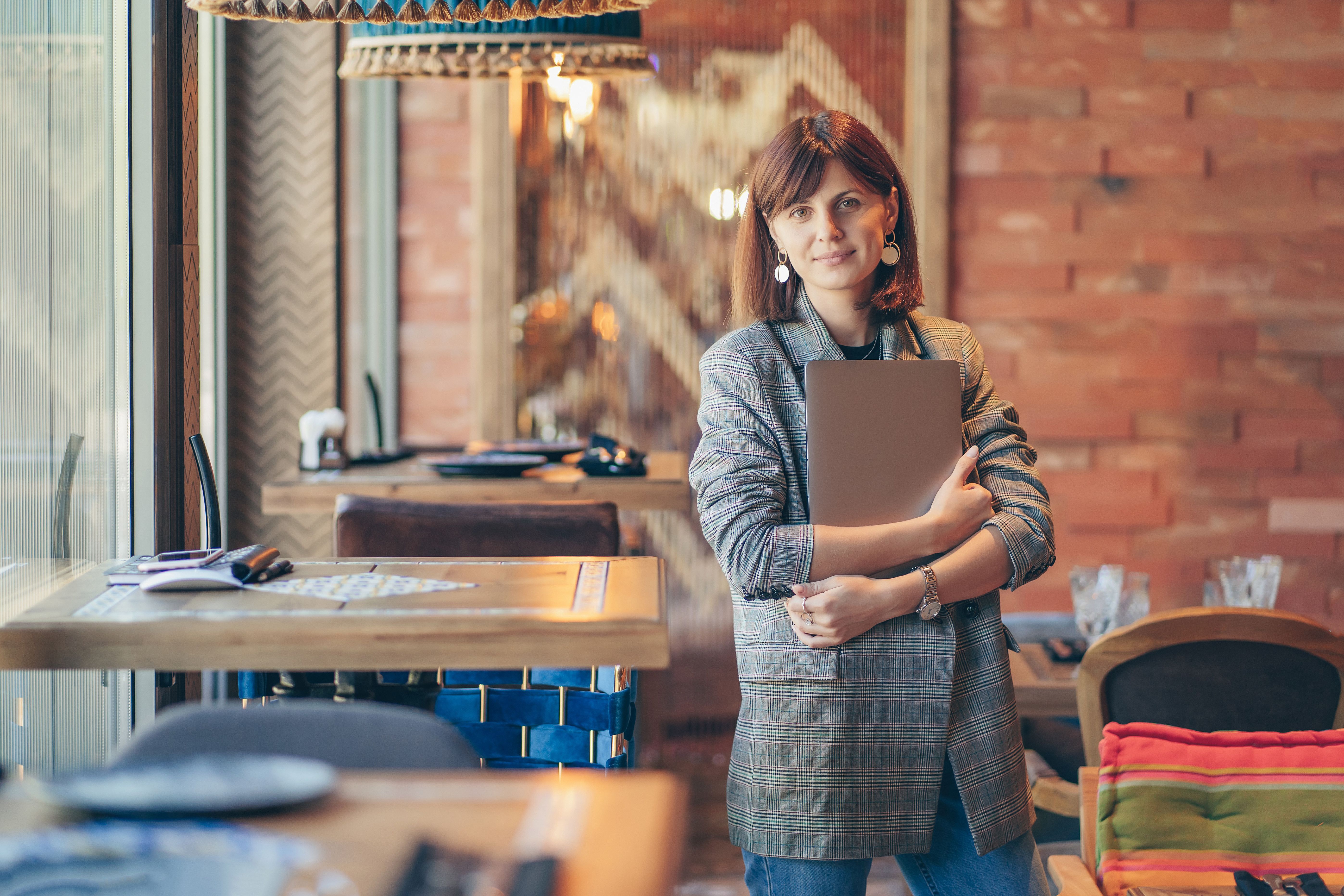 young woman smiling holding ledger