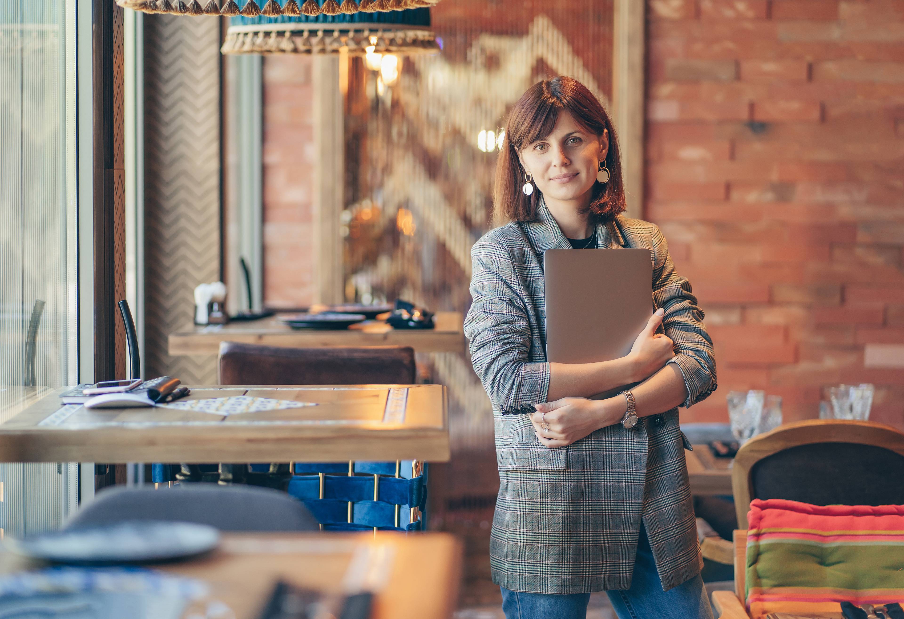 young woman smiling holding ledger
