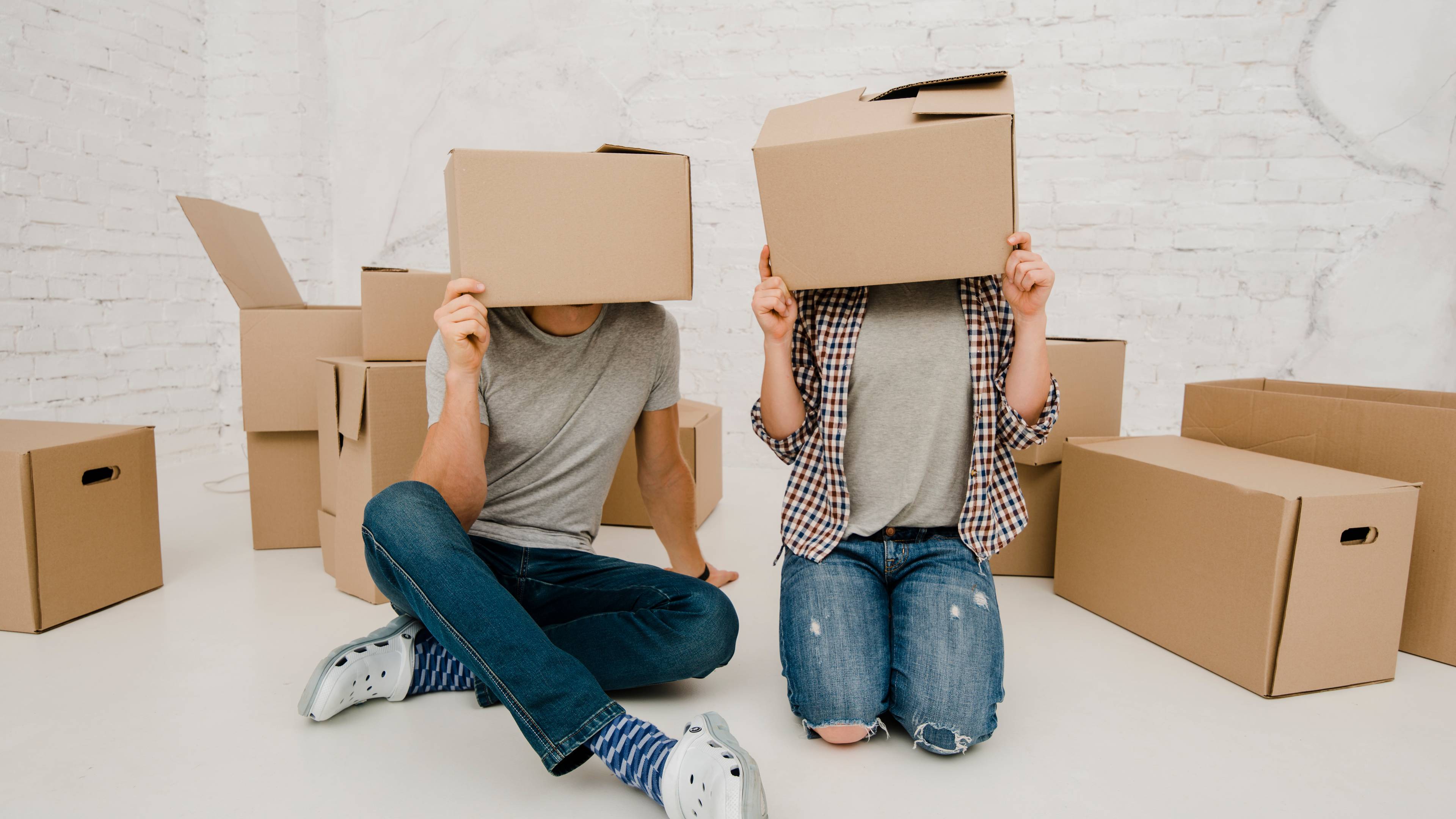 Couple wearing carton boxes over face
