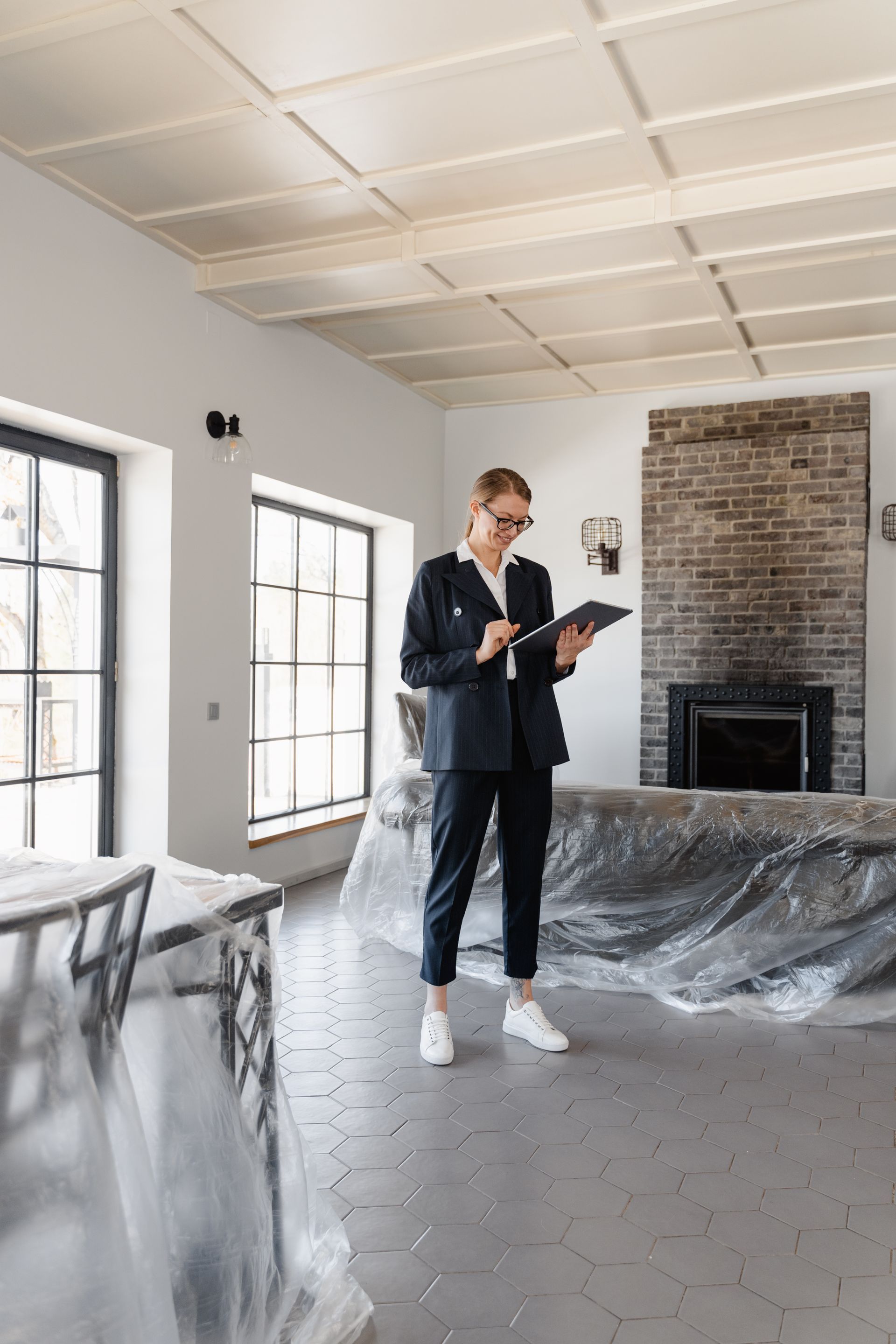 house staged for sale with smiling female estate agent with clipboard