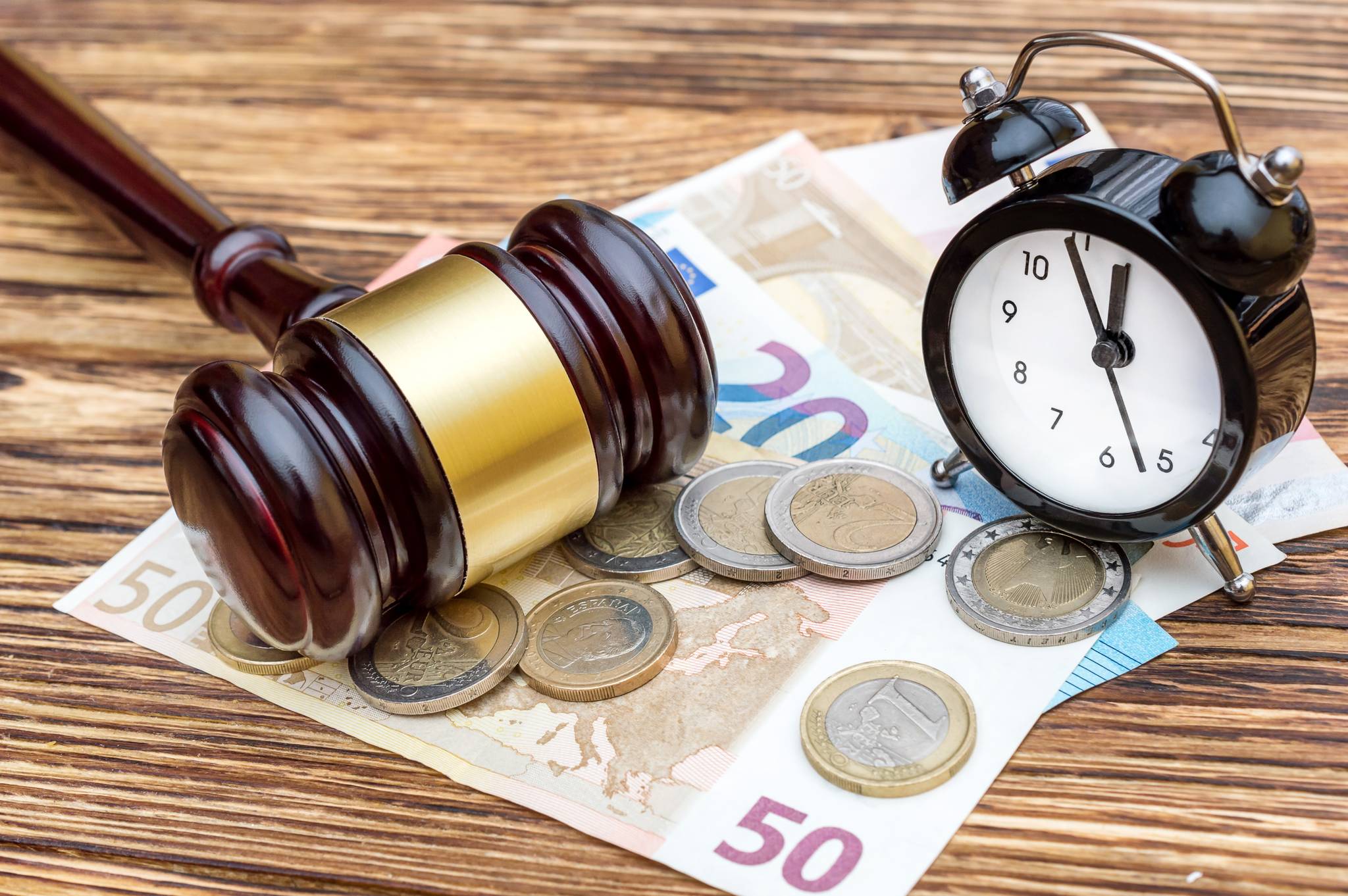 A gavel, some coins, and an alarm clock.