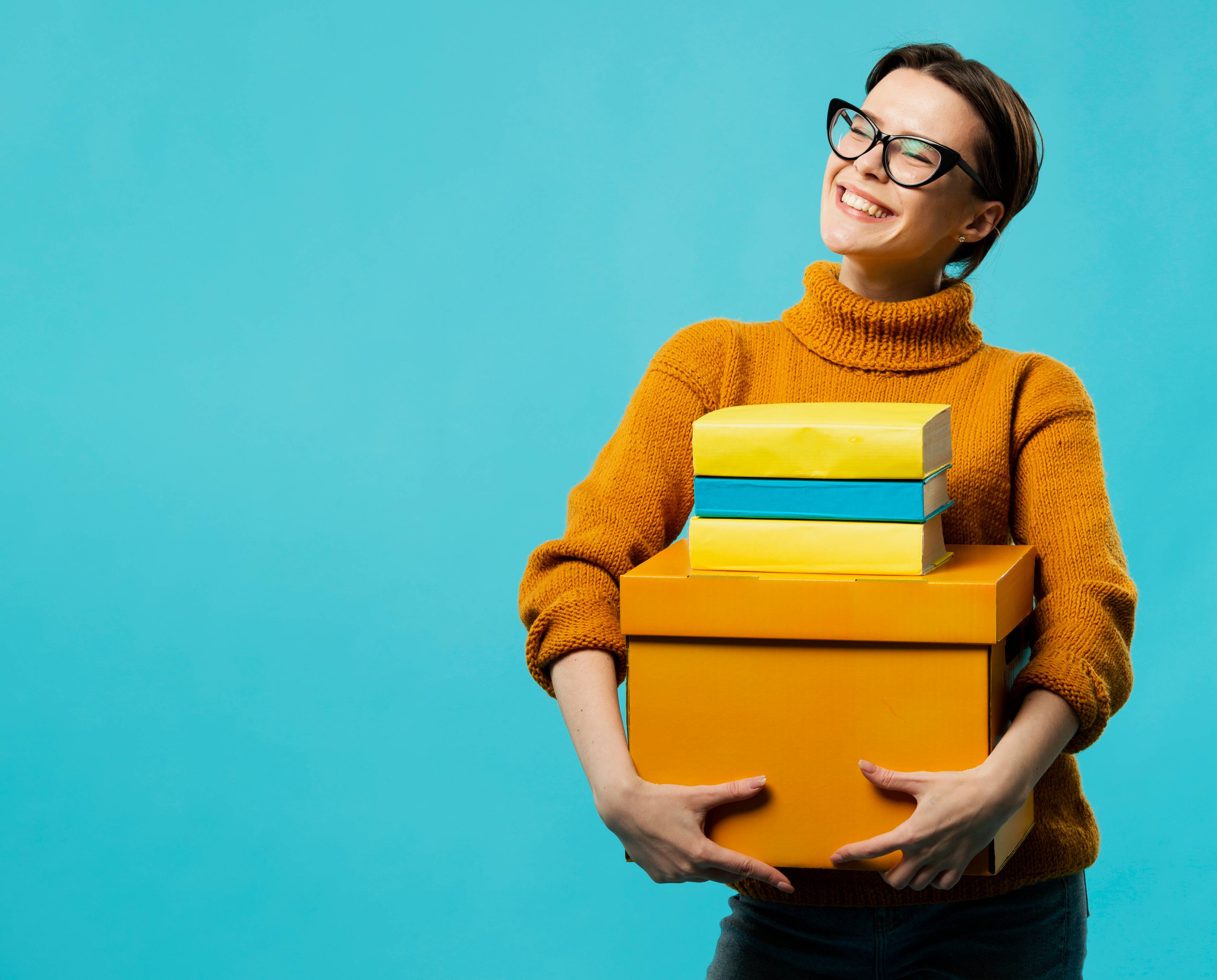 Woman smiling holding boxes