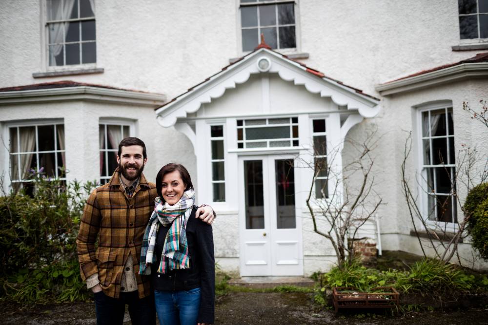 happy couple outside house