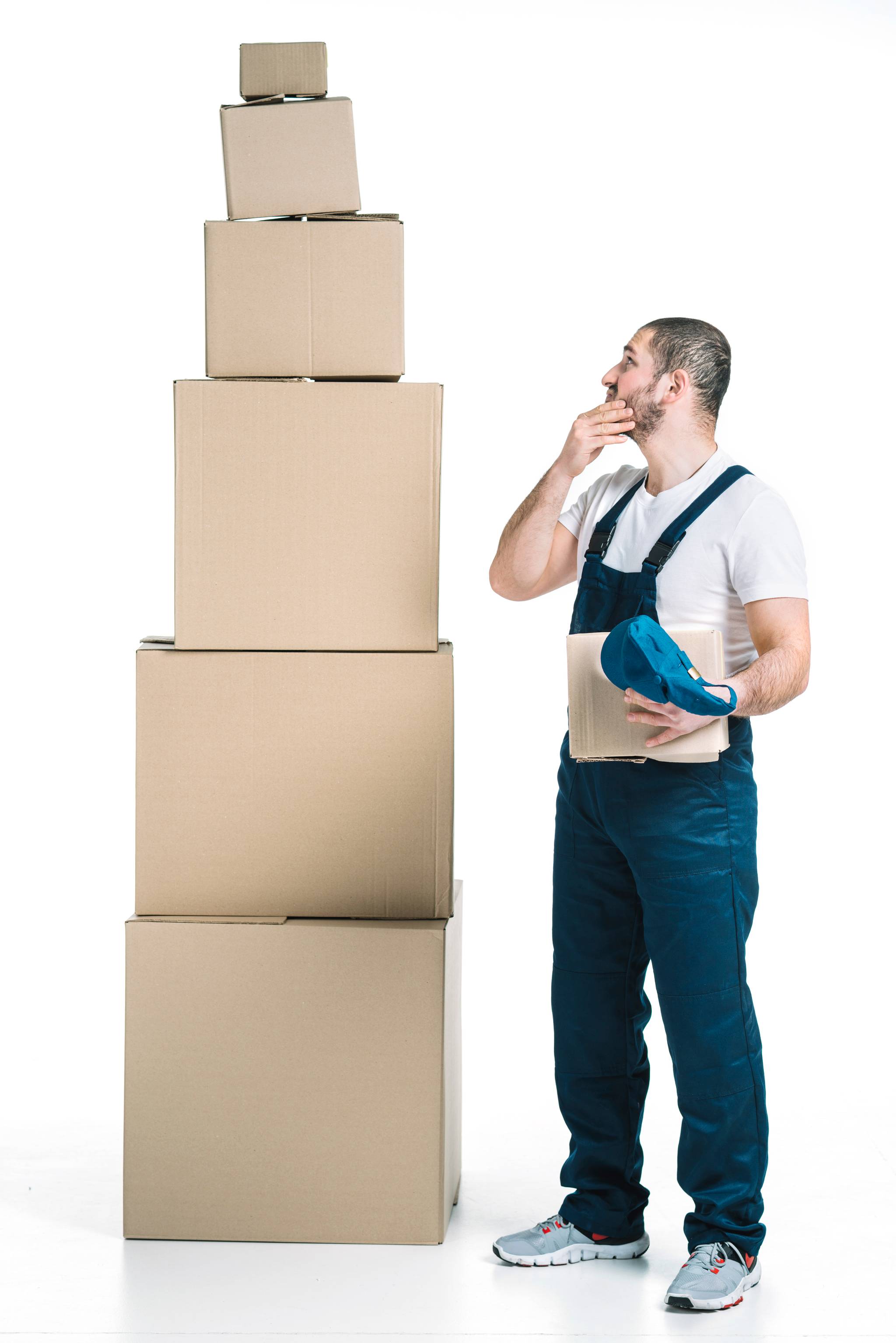 Man standing next to a stack of cardboard boxes