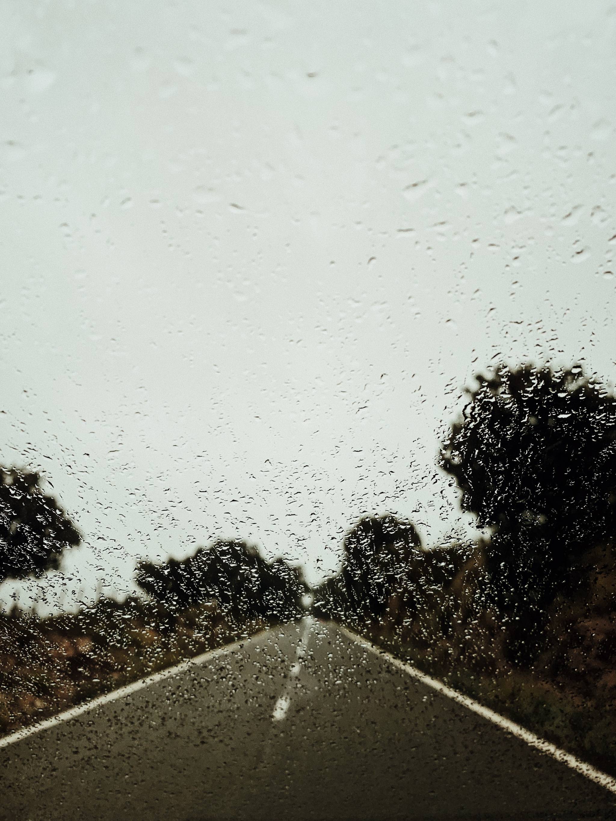 Vertical shot of rain against car