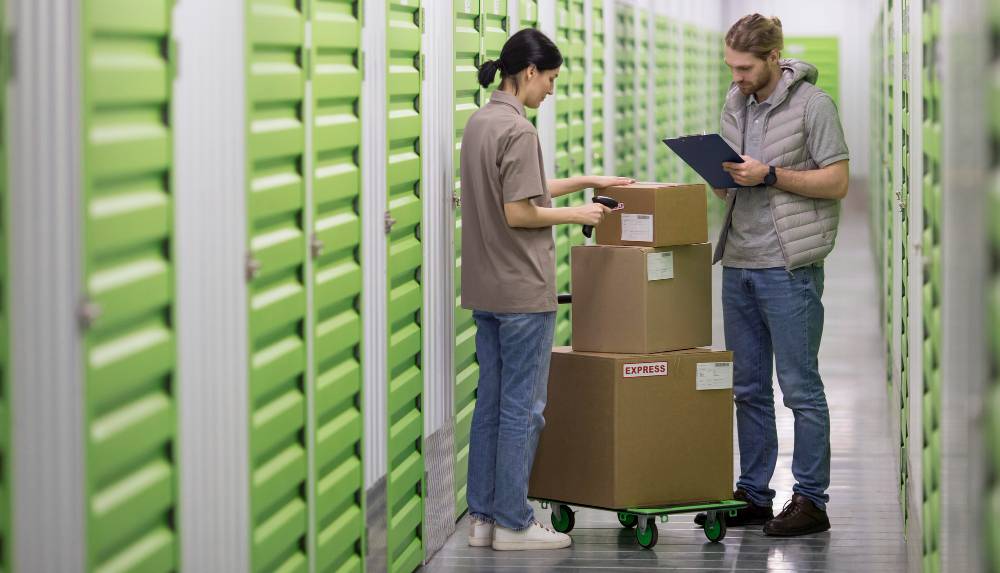 Two people checking boxes before putting them into storage
