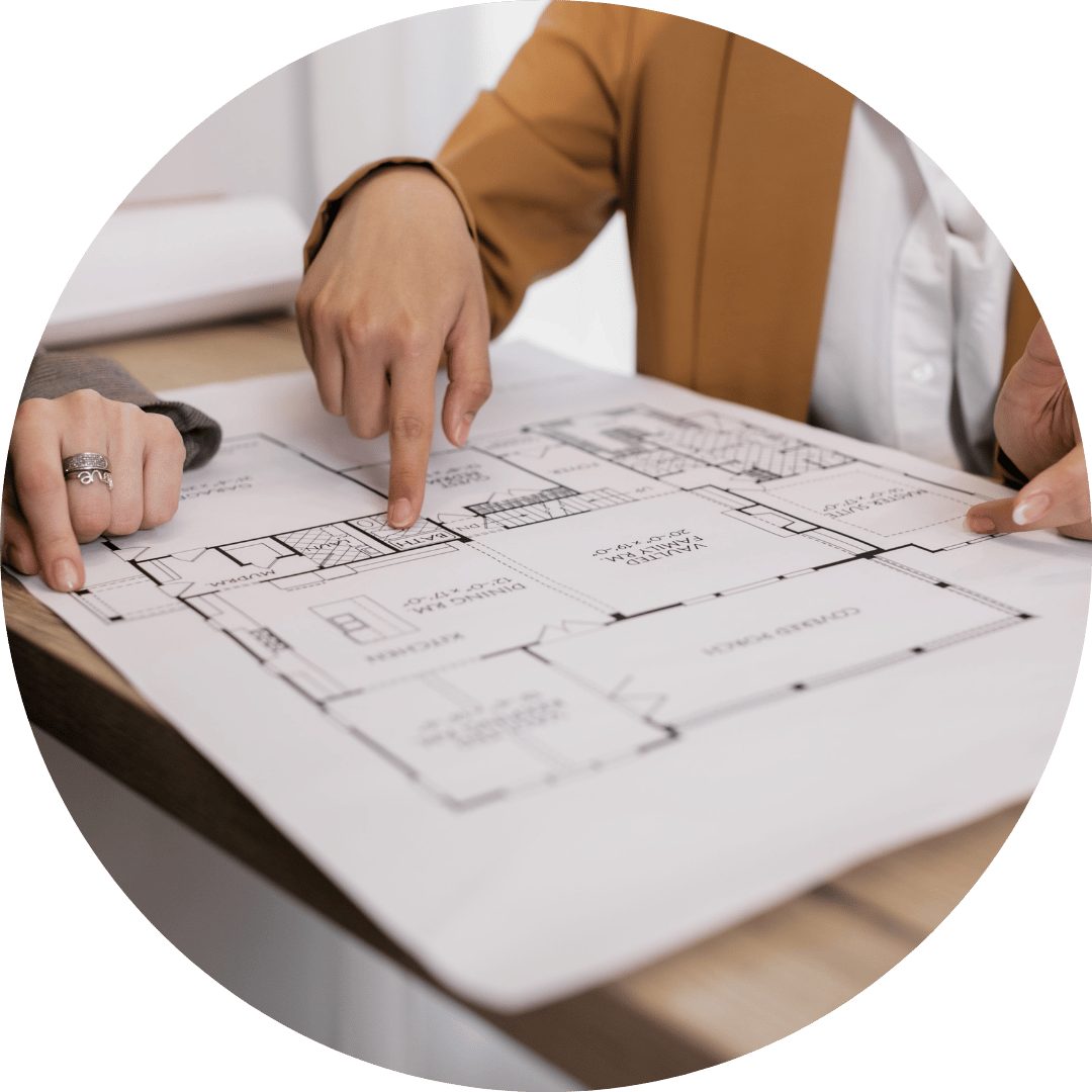 office managers looking at office blueprint for downaizing
