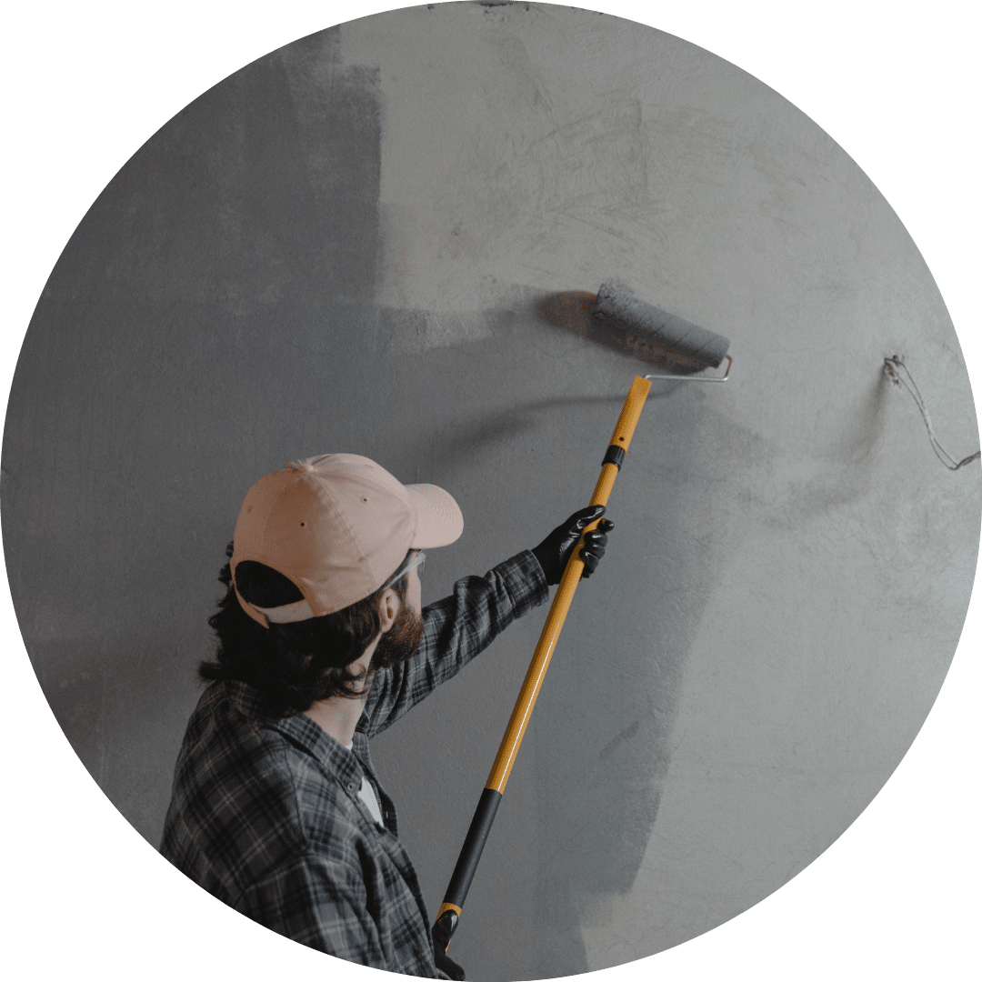 man refurbishing office repainting wall