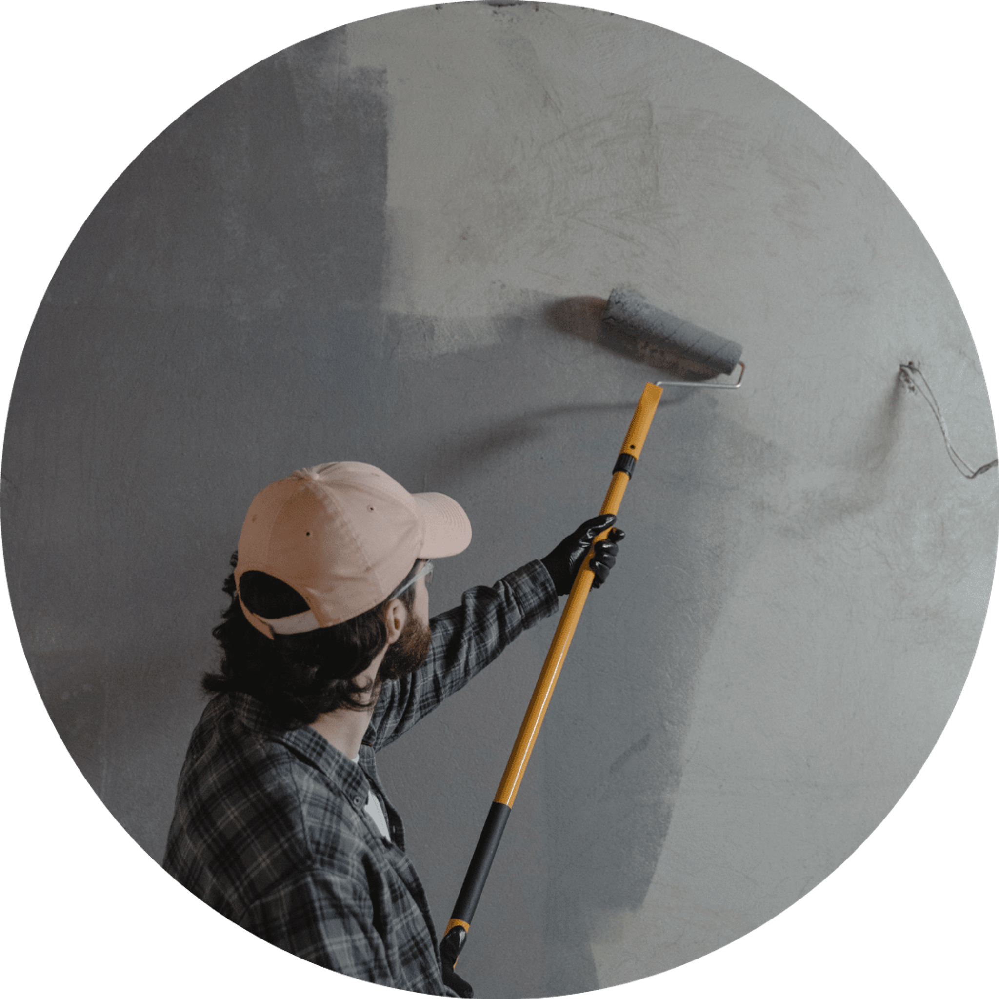 man refurbishing office repainting wall