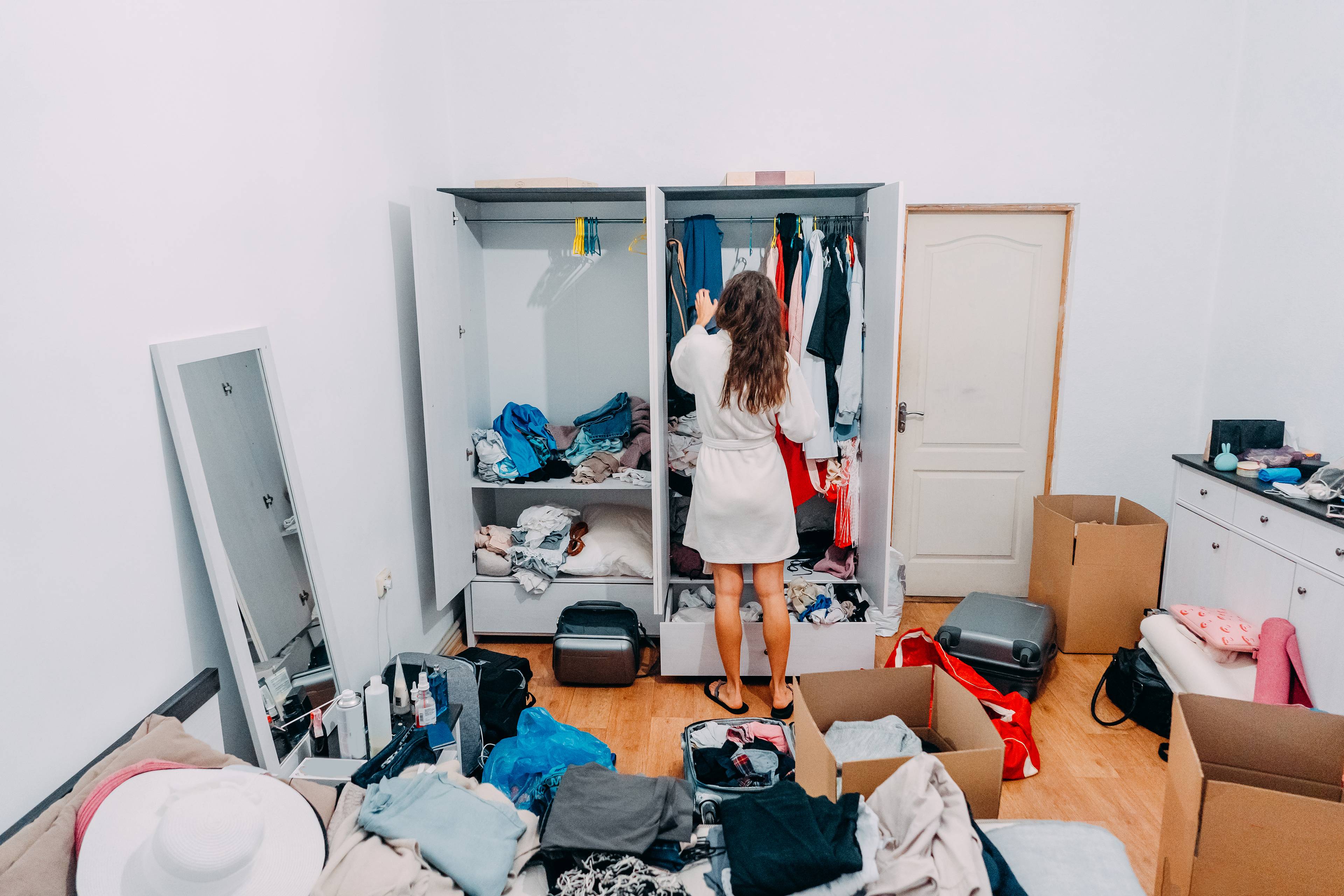 Lady looking around apartment for things to declutter