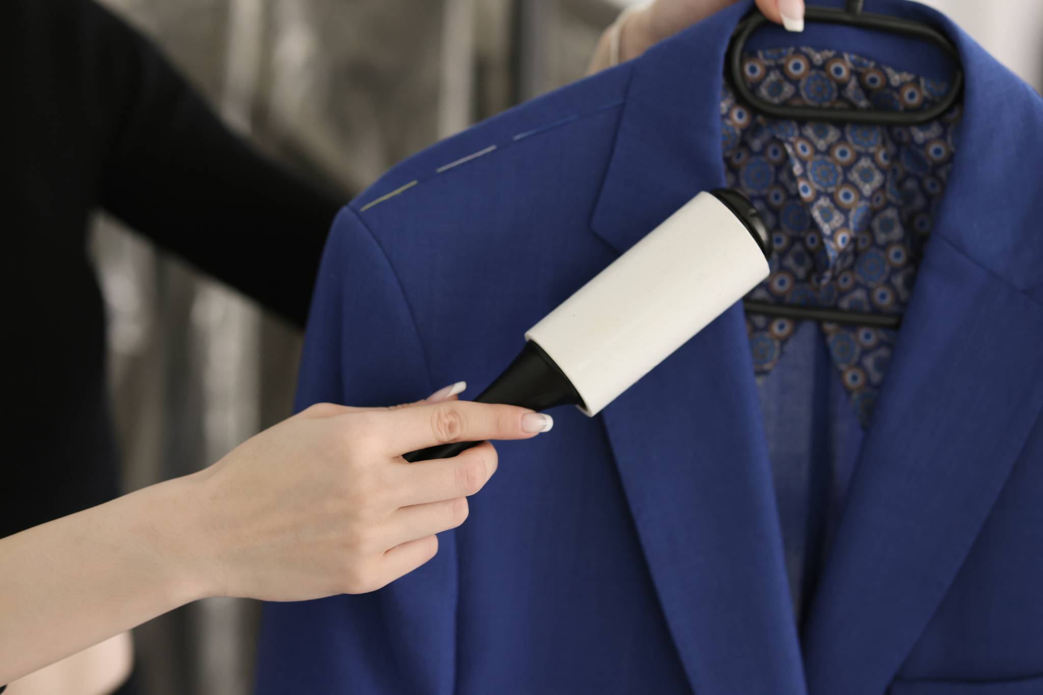 Woman cleaning a navy blue coat