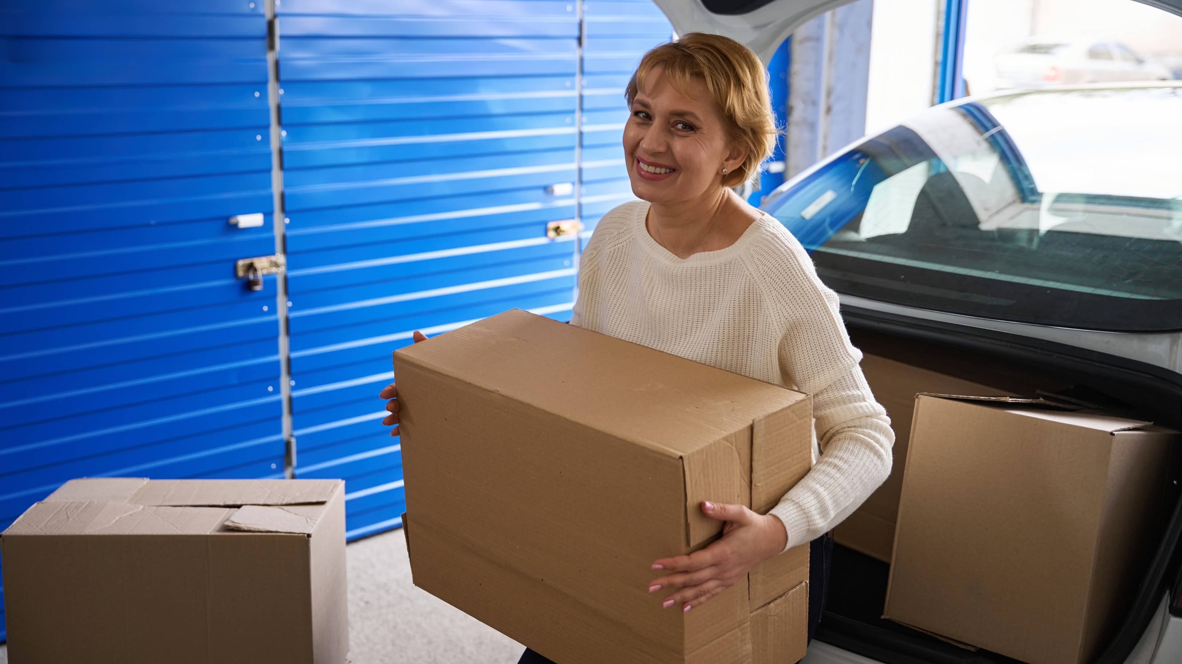Lady carrying a large cardboard box