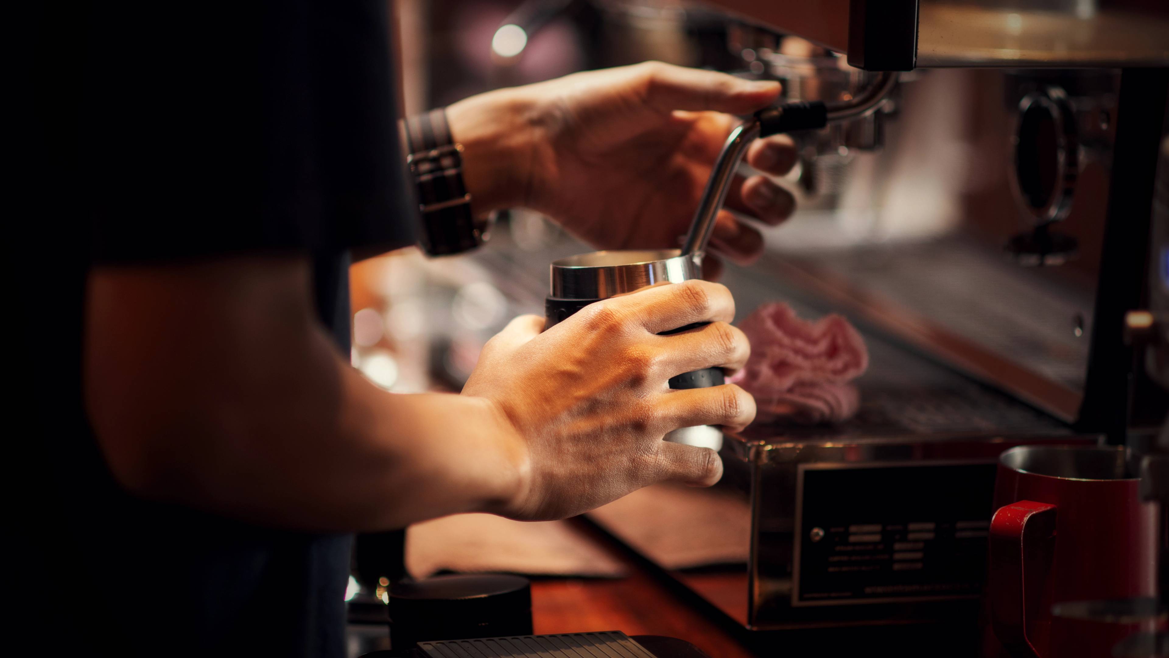 Close up barista making cappuccino, bartender preparing coffee drink