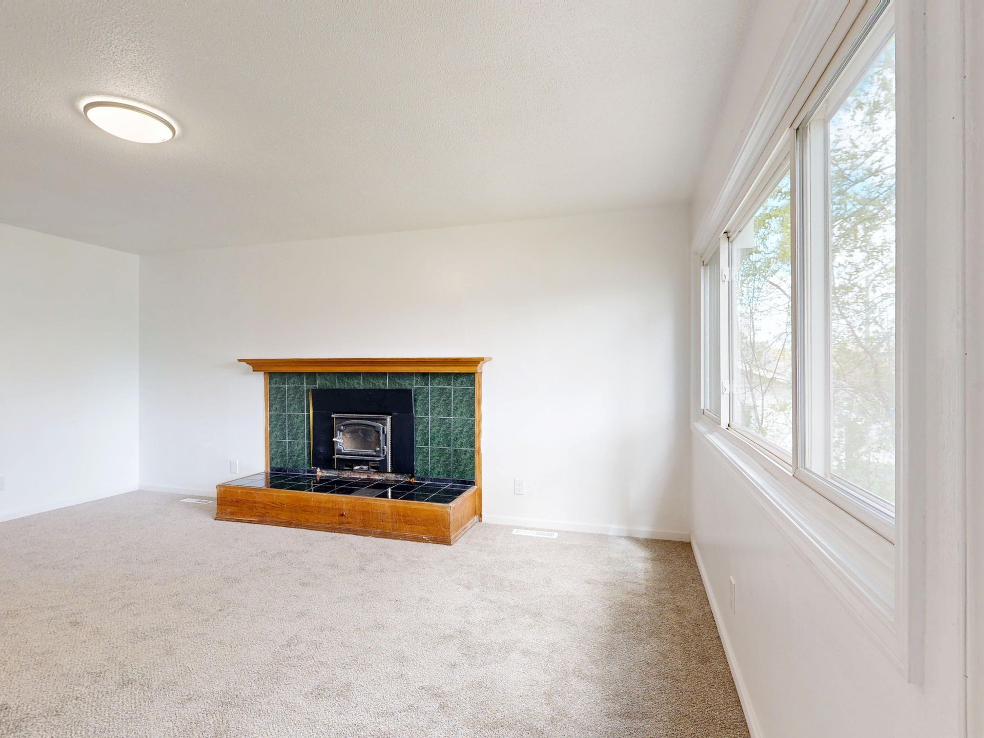 house staged for sale fireplace living room emptied of furniture