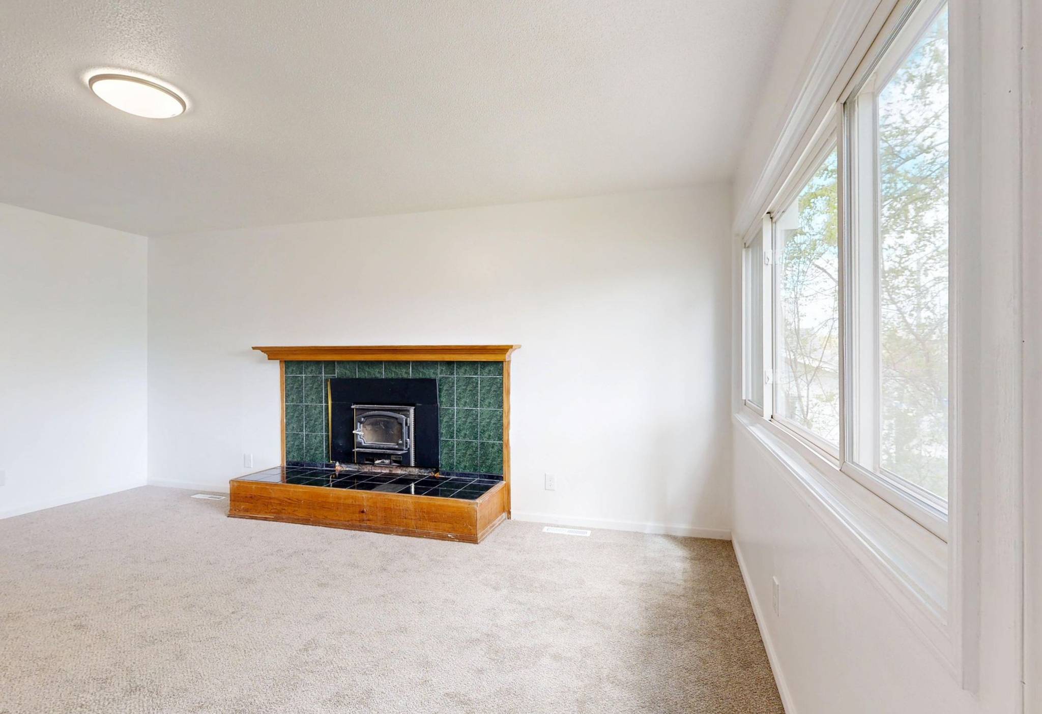 house staged for sale fireplace living room emptied of furniture