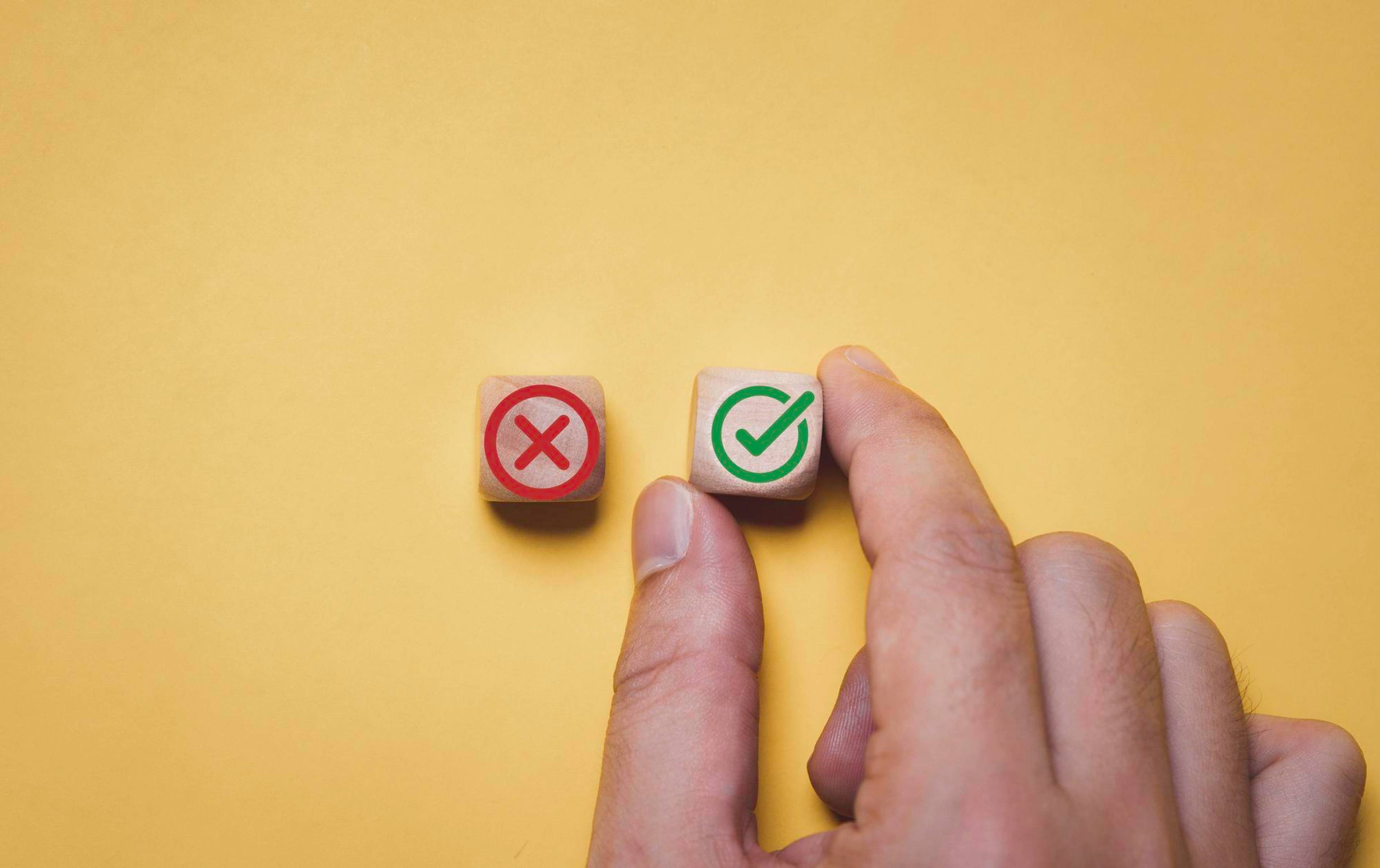 Man choosing dice with green checkmark