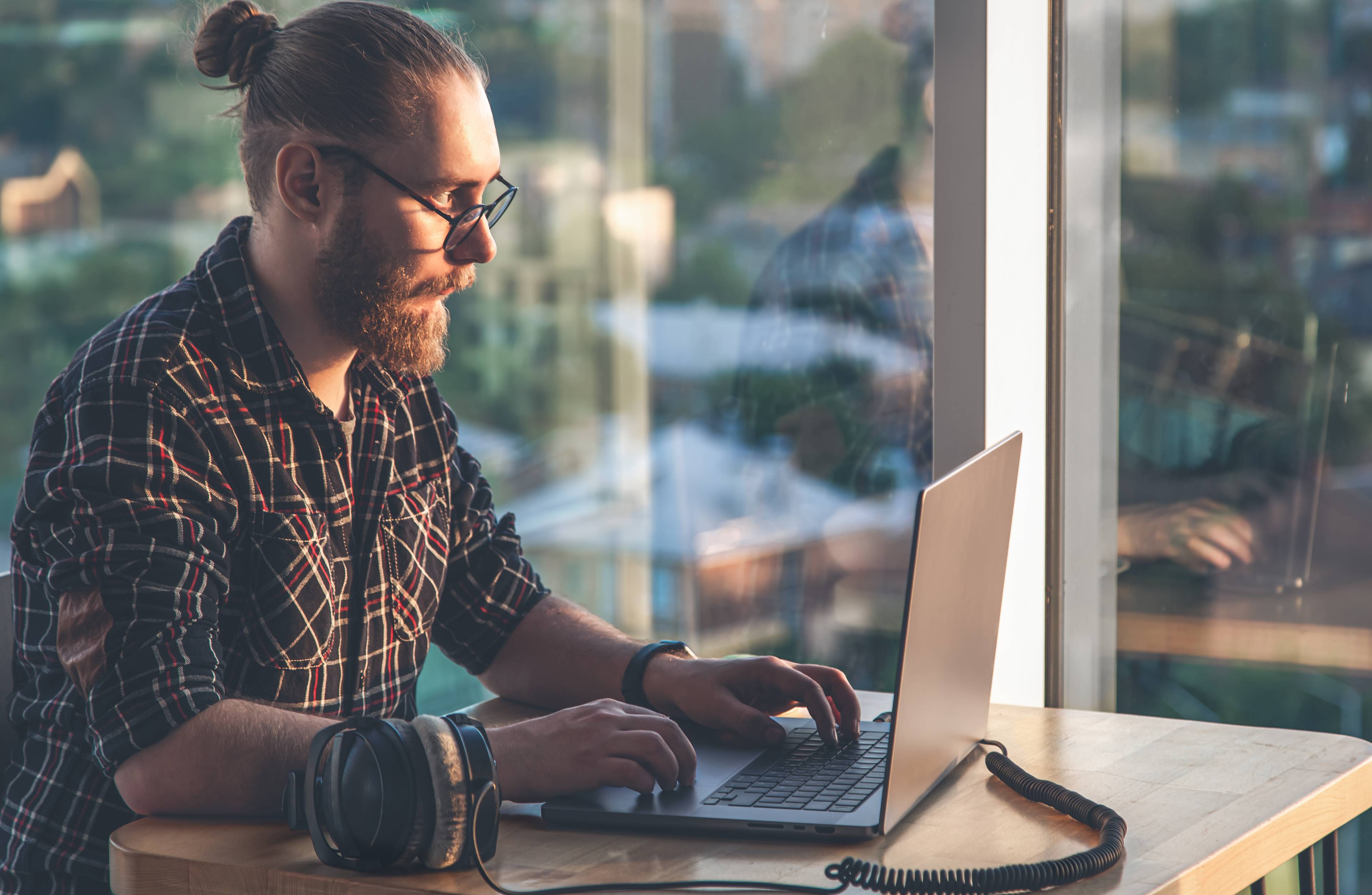 Man with beard on computer