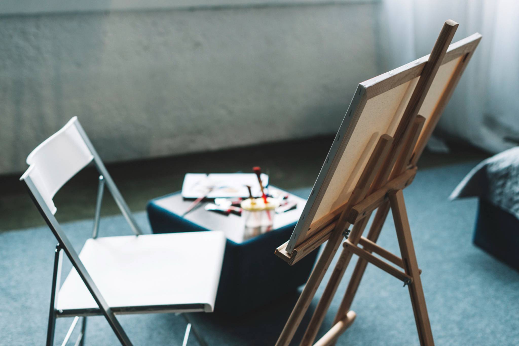 chair and easel with a canvas ready to be painted