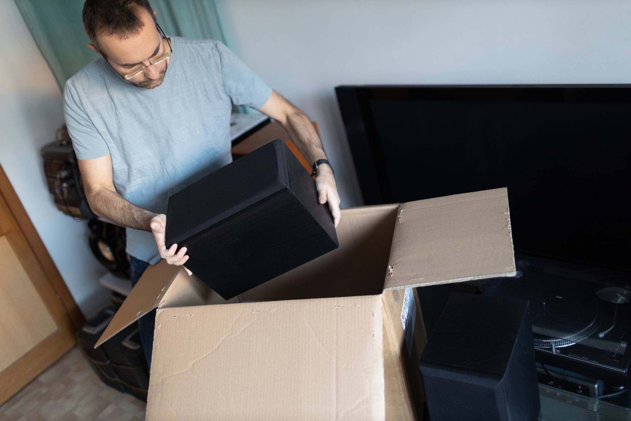 man packing box with electronics