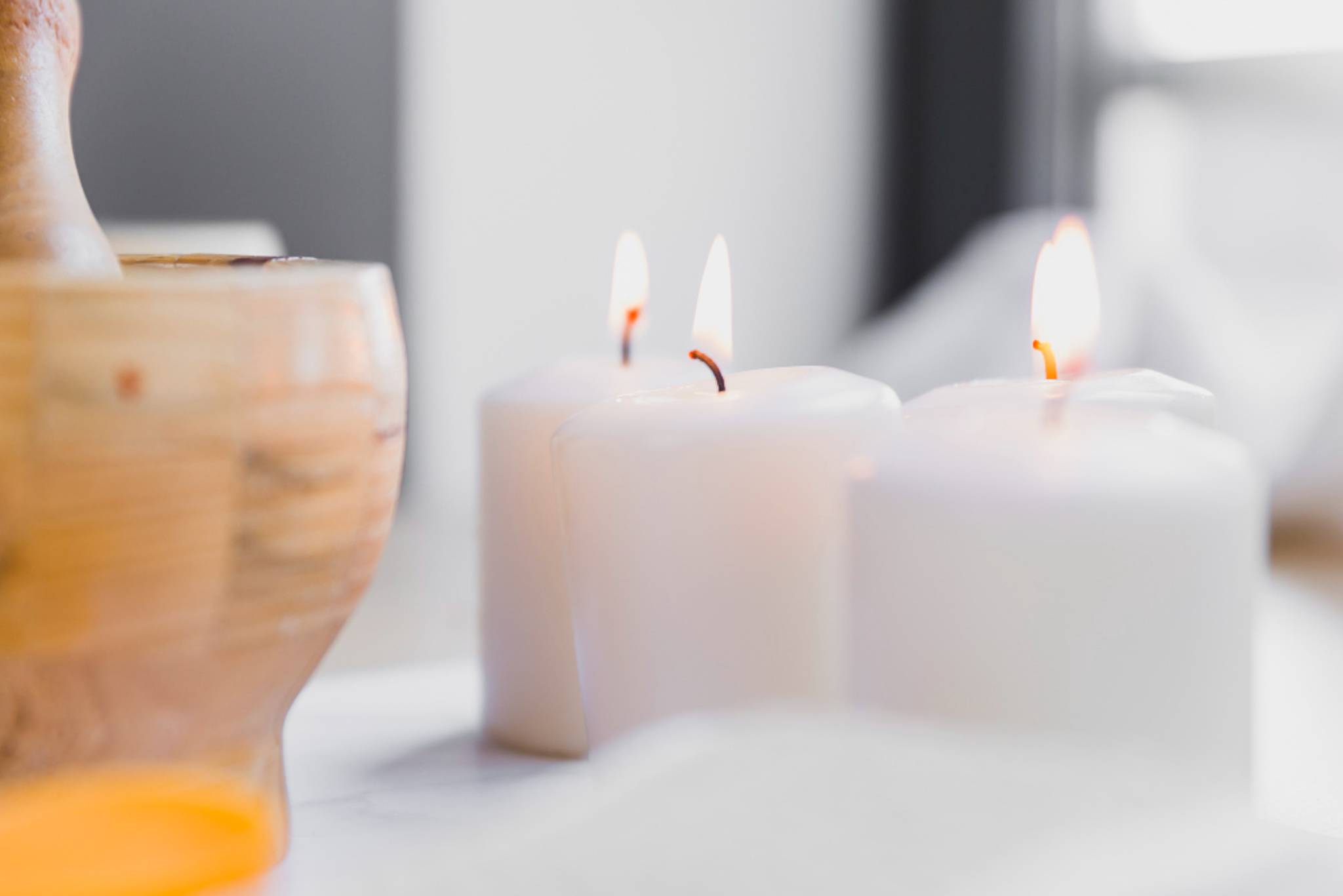 White lit candles on a table together