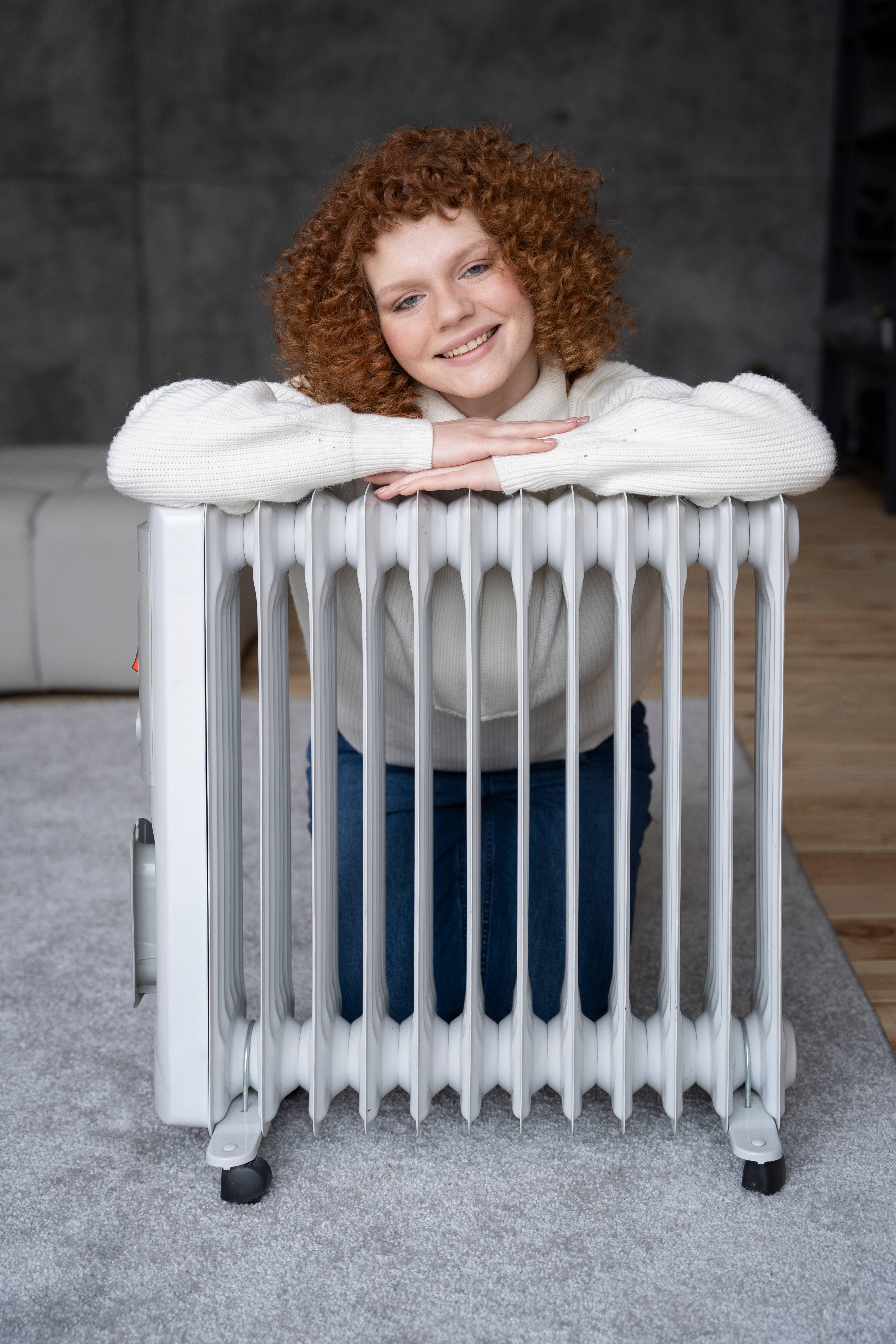 Woman sitting behind a heataer