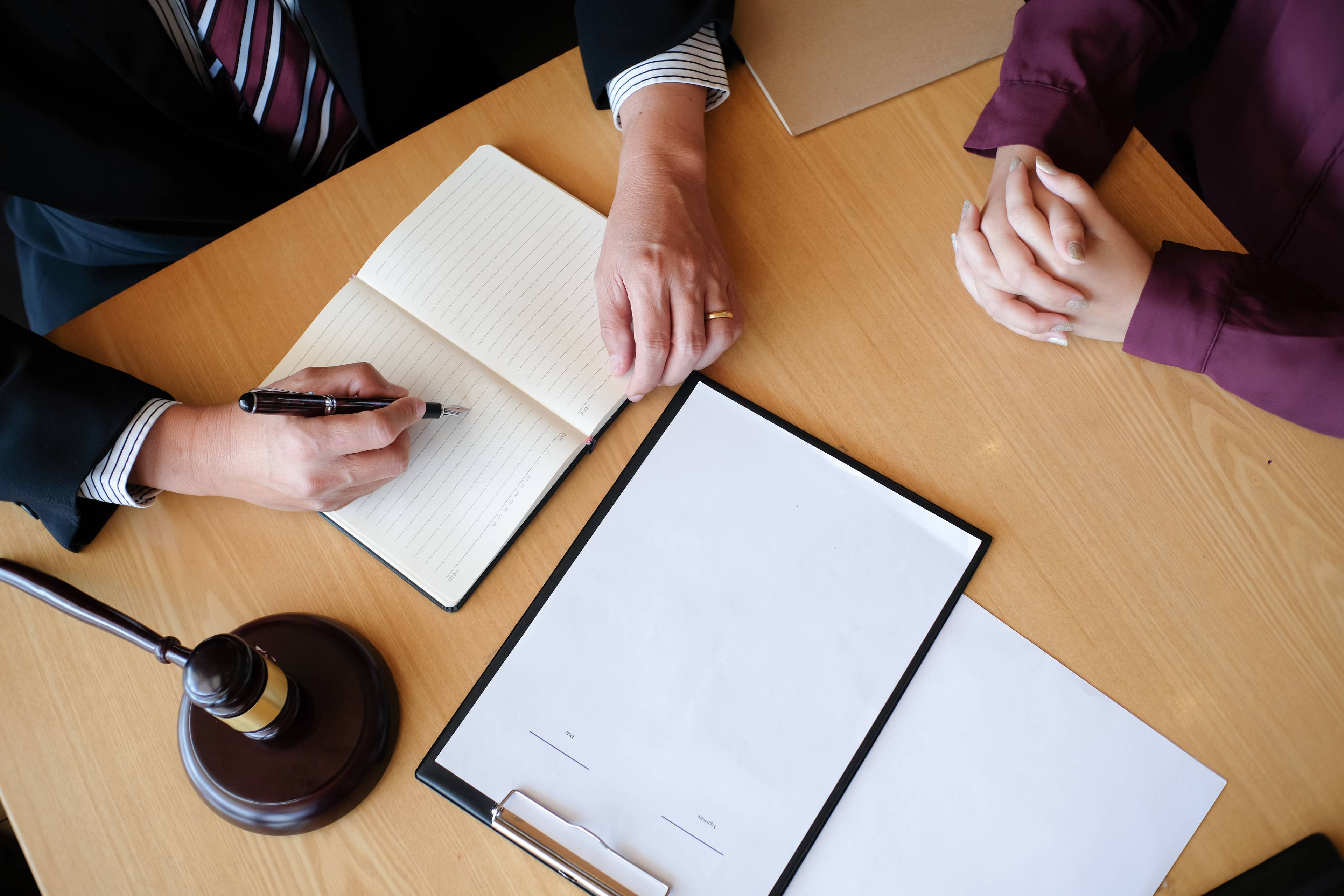 high angle view of 2 people writing documents