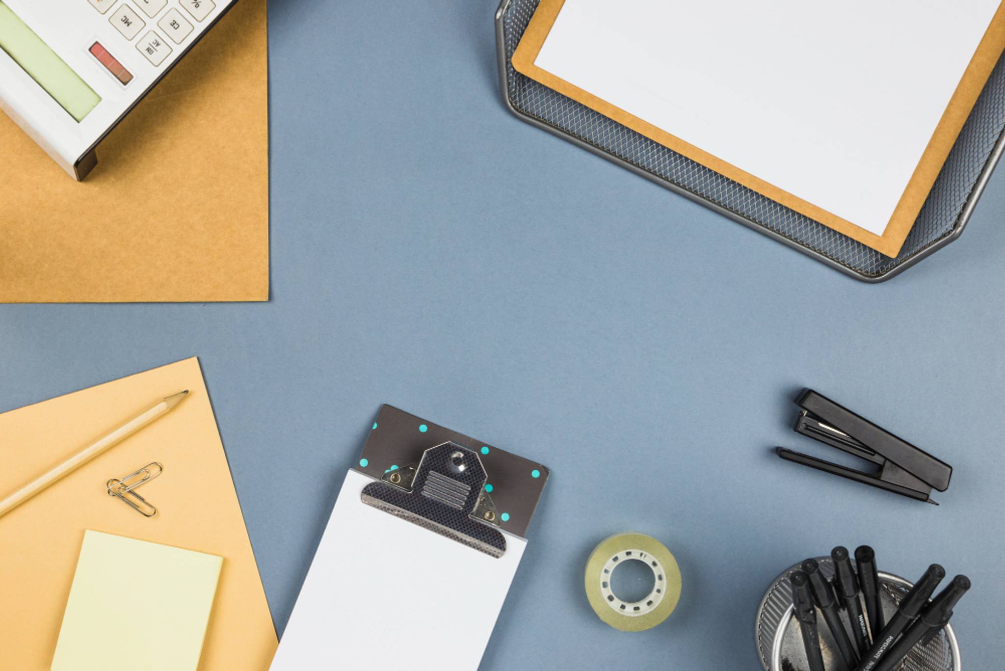 A variety of office supplies laying on a table.