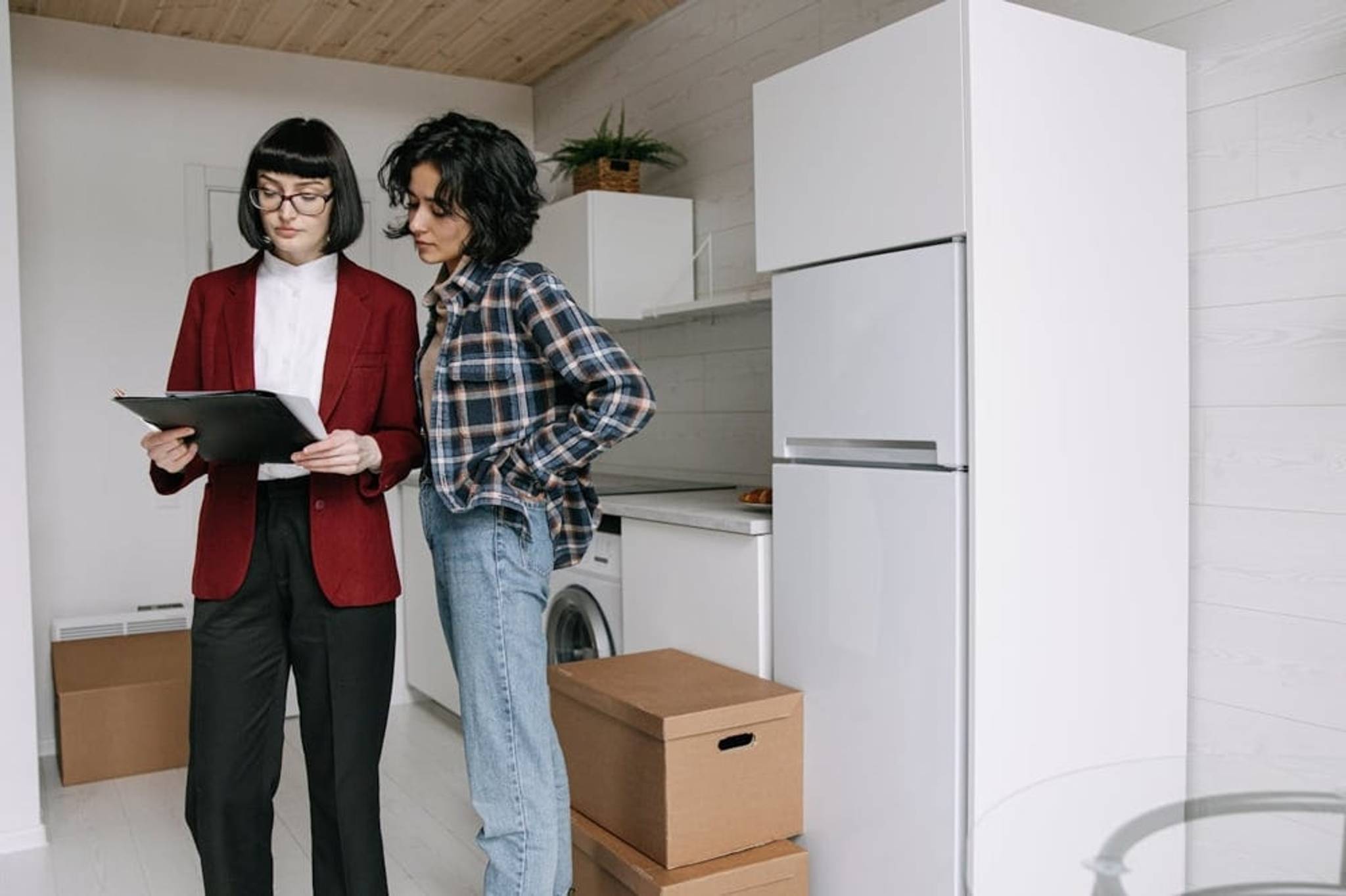 Two woman prepaing to move in empty house