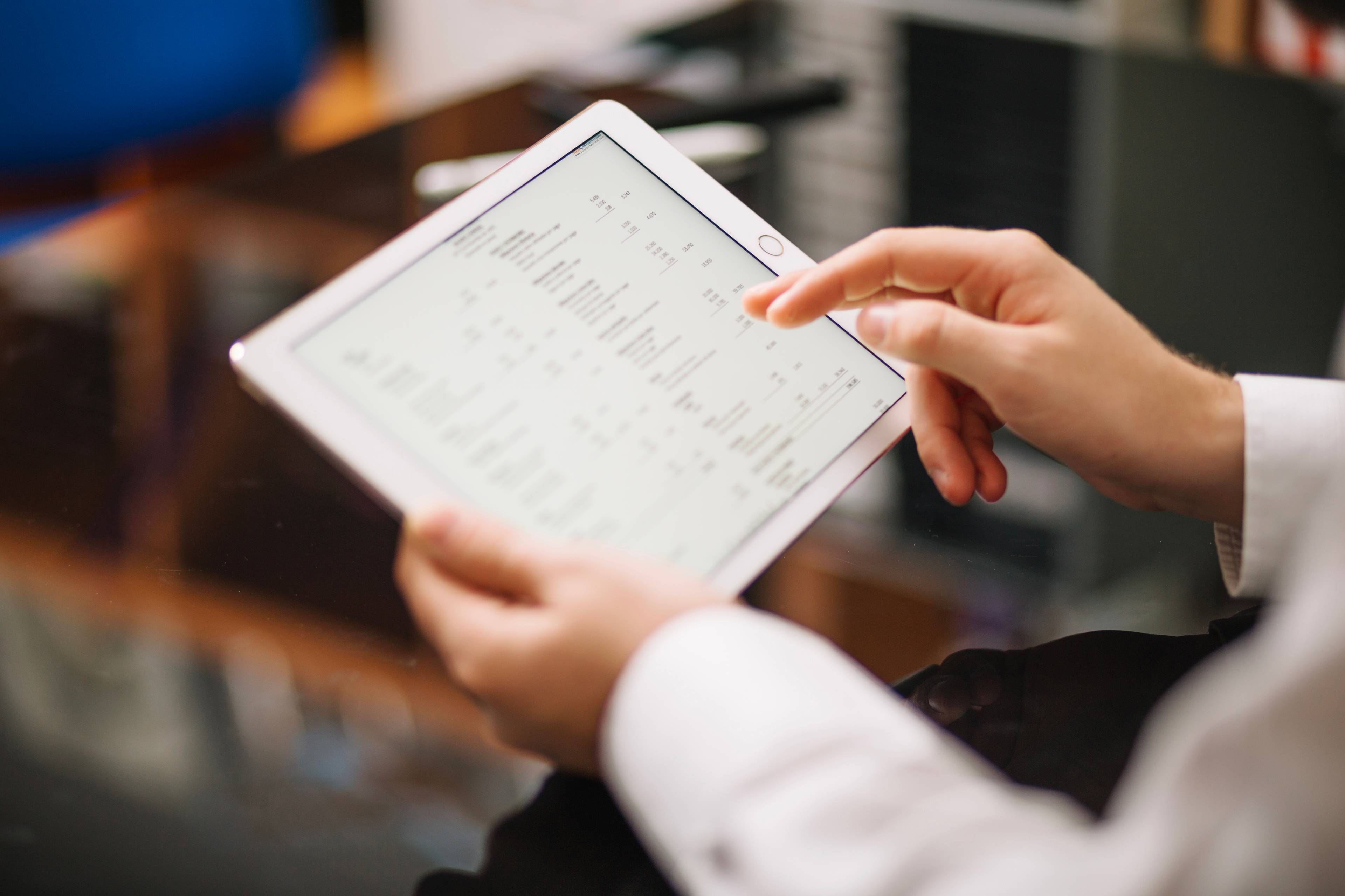 warehouse manager typing on tablet