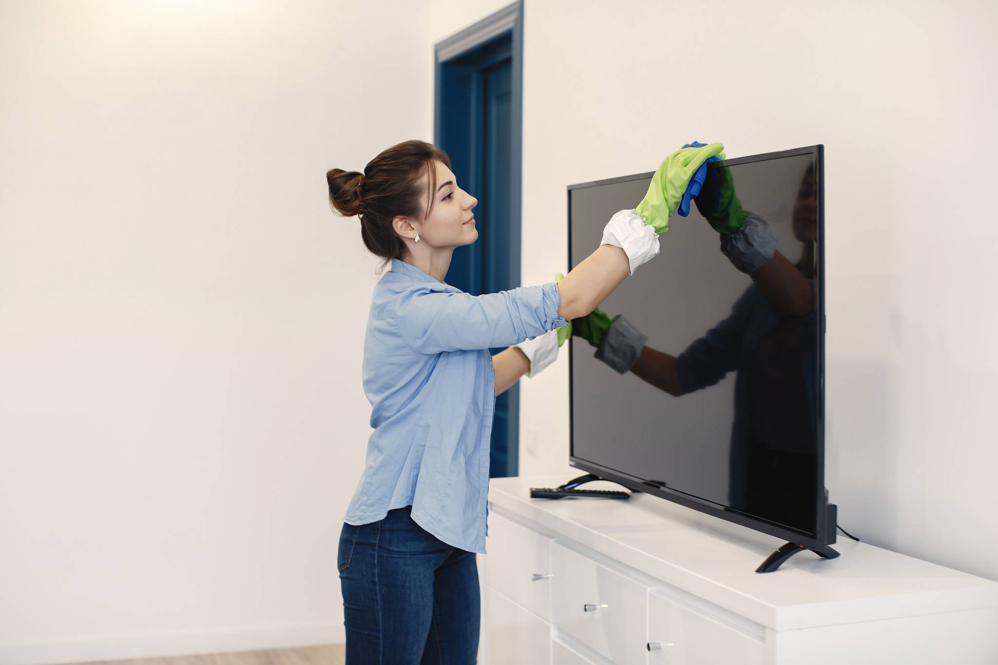 woman cleaning tv