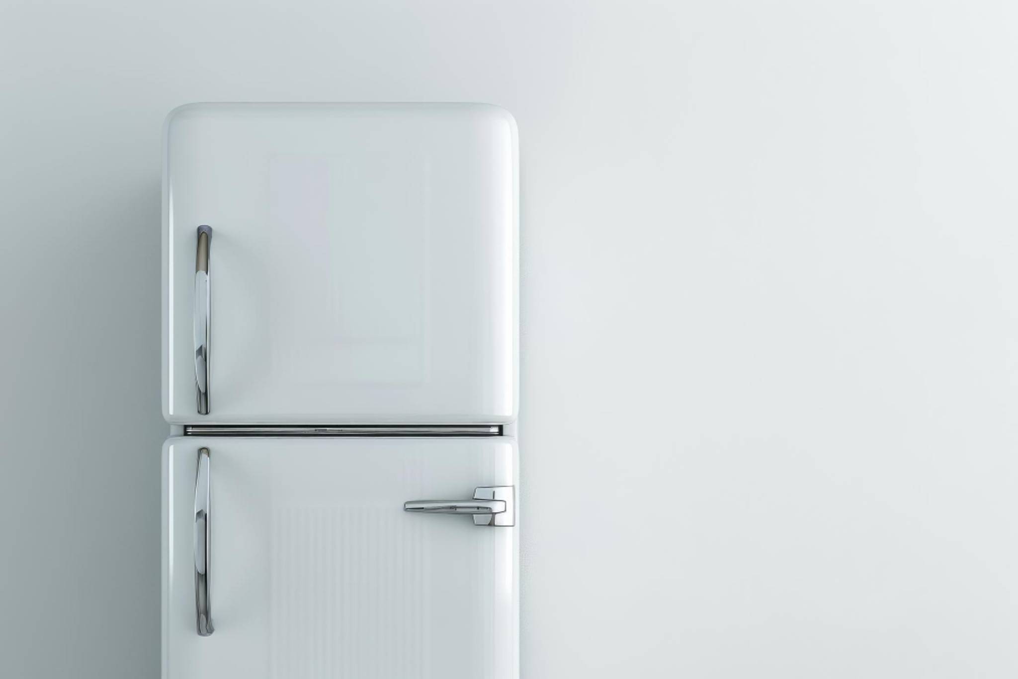 Silver fridge-freezer in a white room