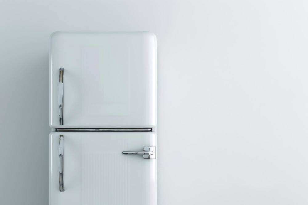 Silver fridge-freezer in a white room