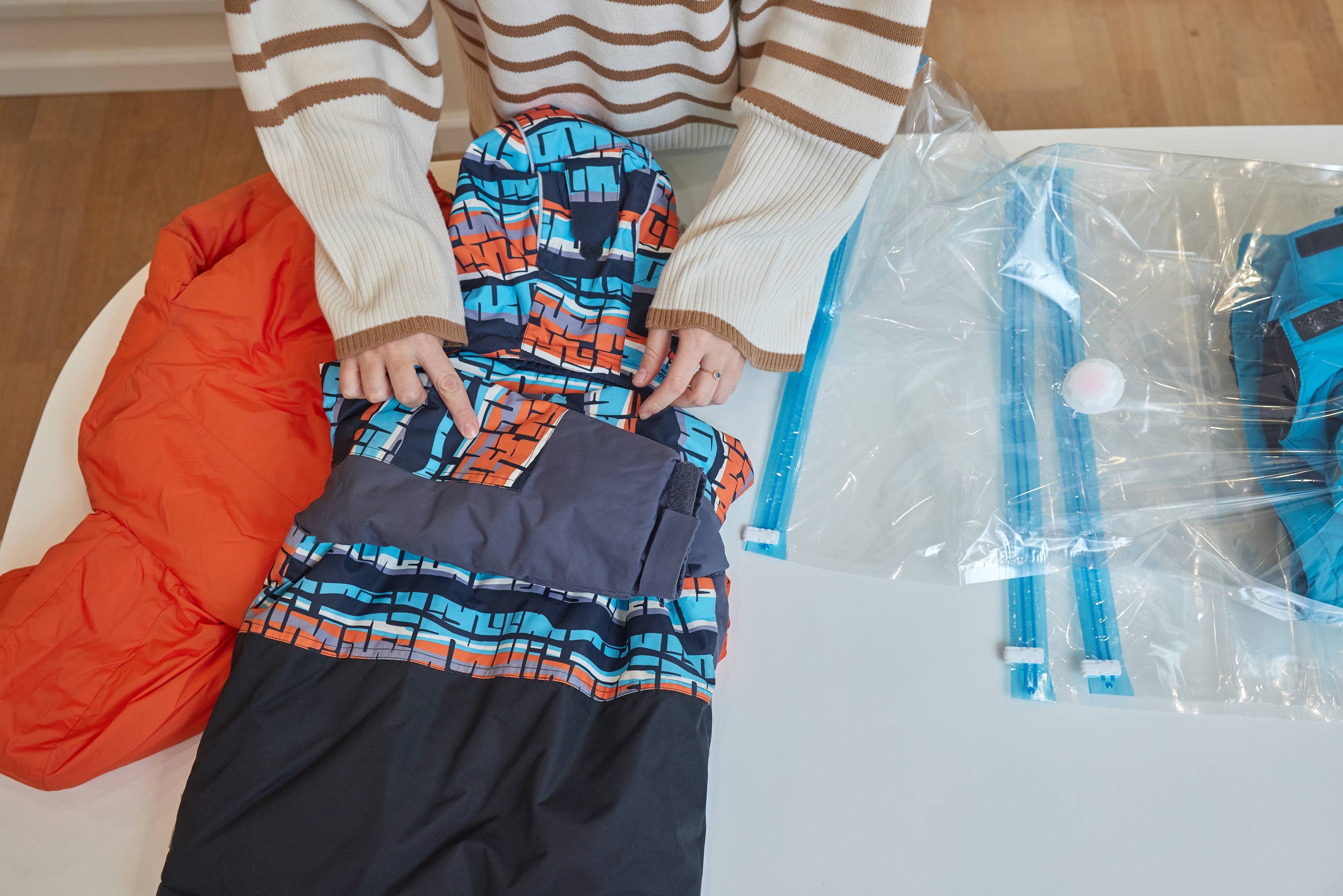 Woman packing clothes in plastic bags