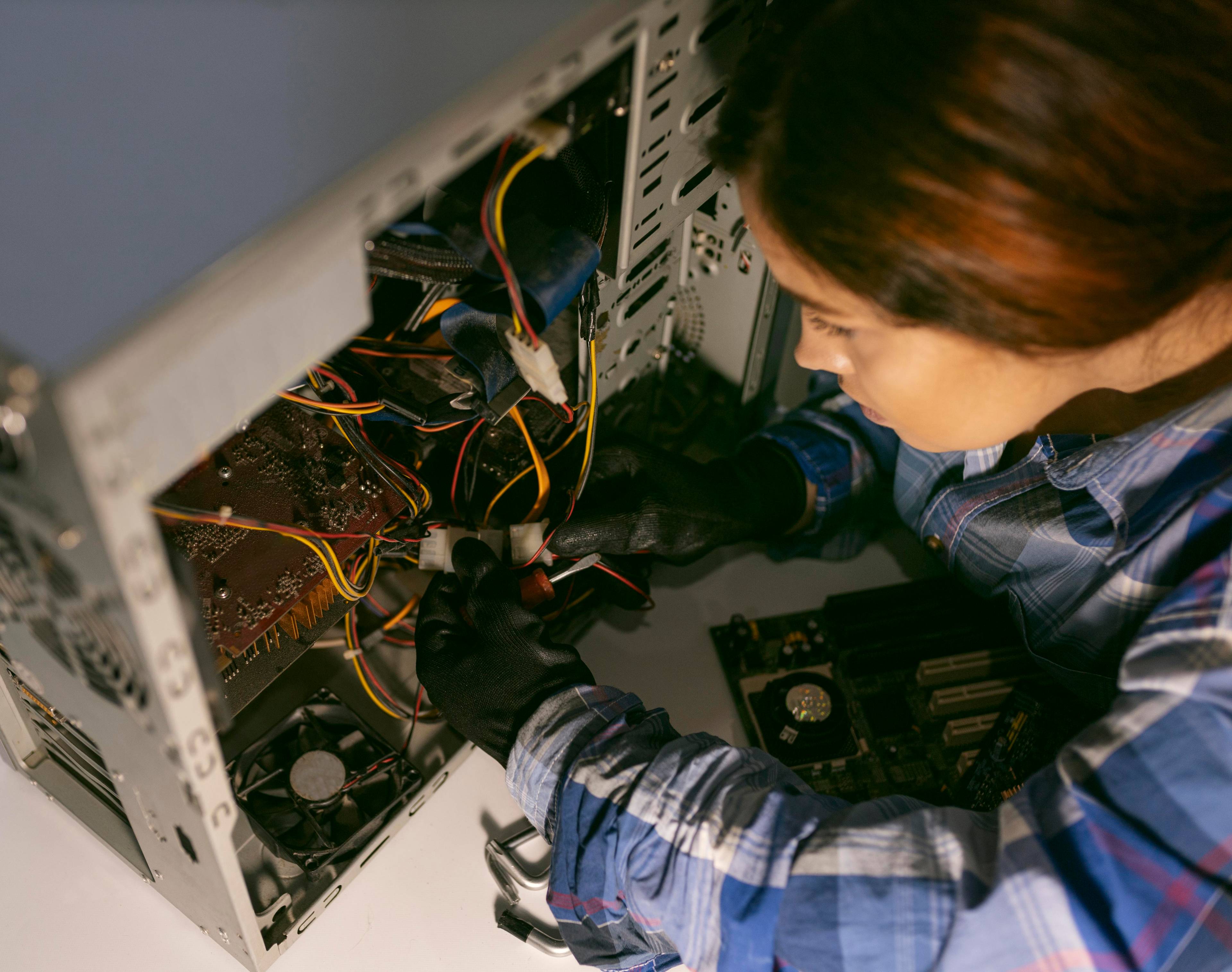 Woman fixing computer wires