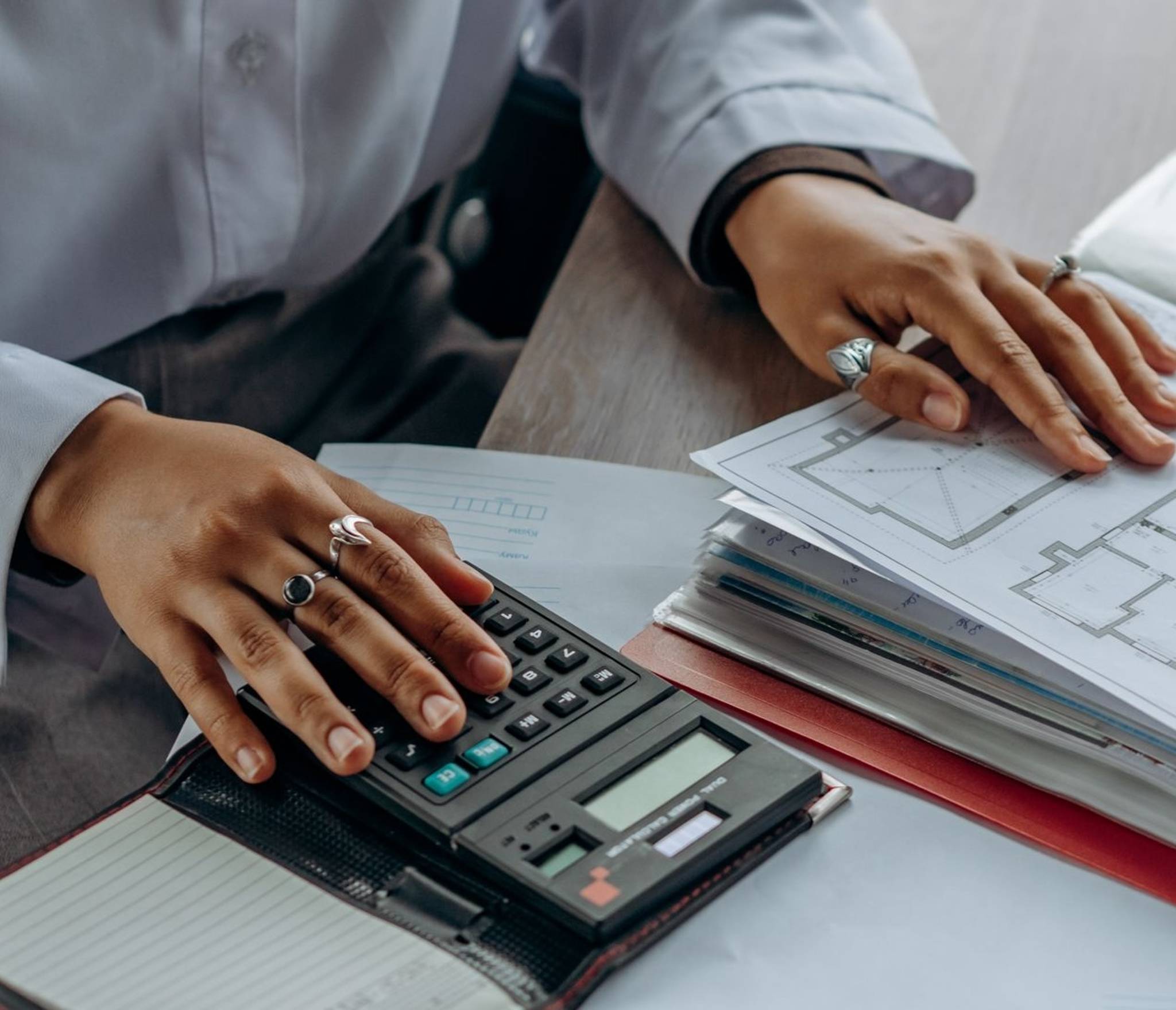 office worker auditing assets with calculator and files